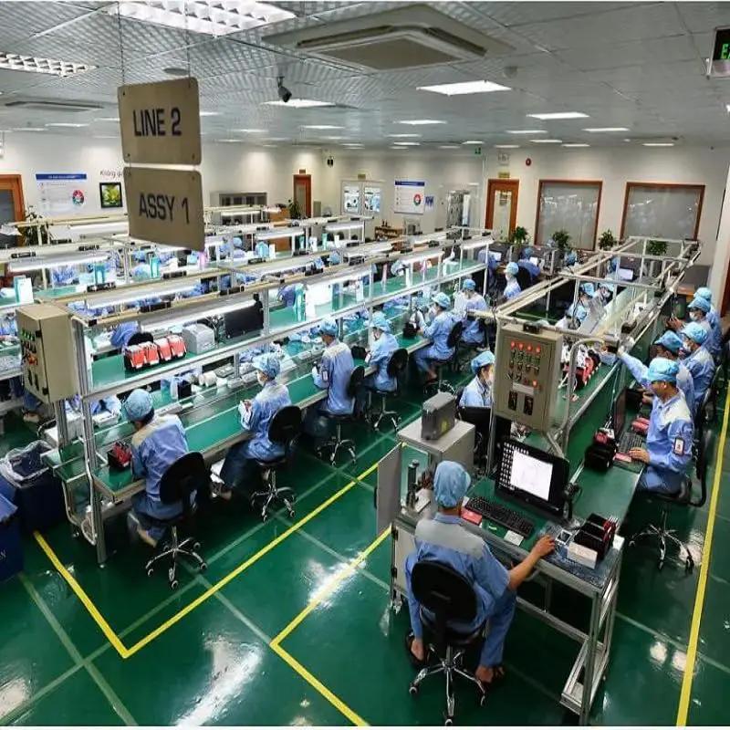 Workers assembling in an electronics manufacturing facility, focused on producing components