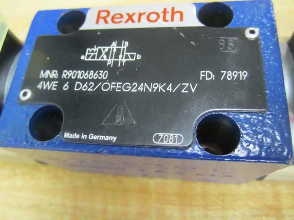 Close-up of 4WE 6 D62/OFEG24N9K4/ZV Directional Solenoid Spool Valve R901068630, showing label and part number, electric blue casing.