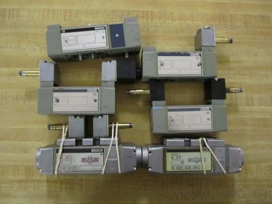 Hydraulic control valve pack 6-piece repair set for parts or refurbishment, showing six industrial valves on a wooden surface.