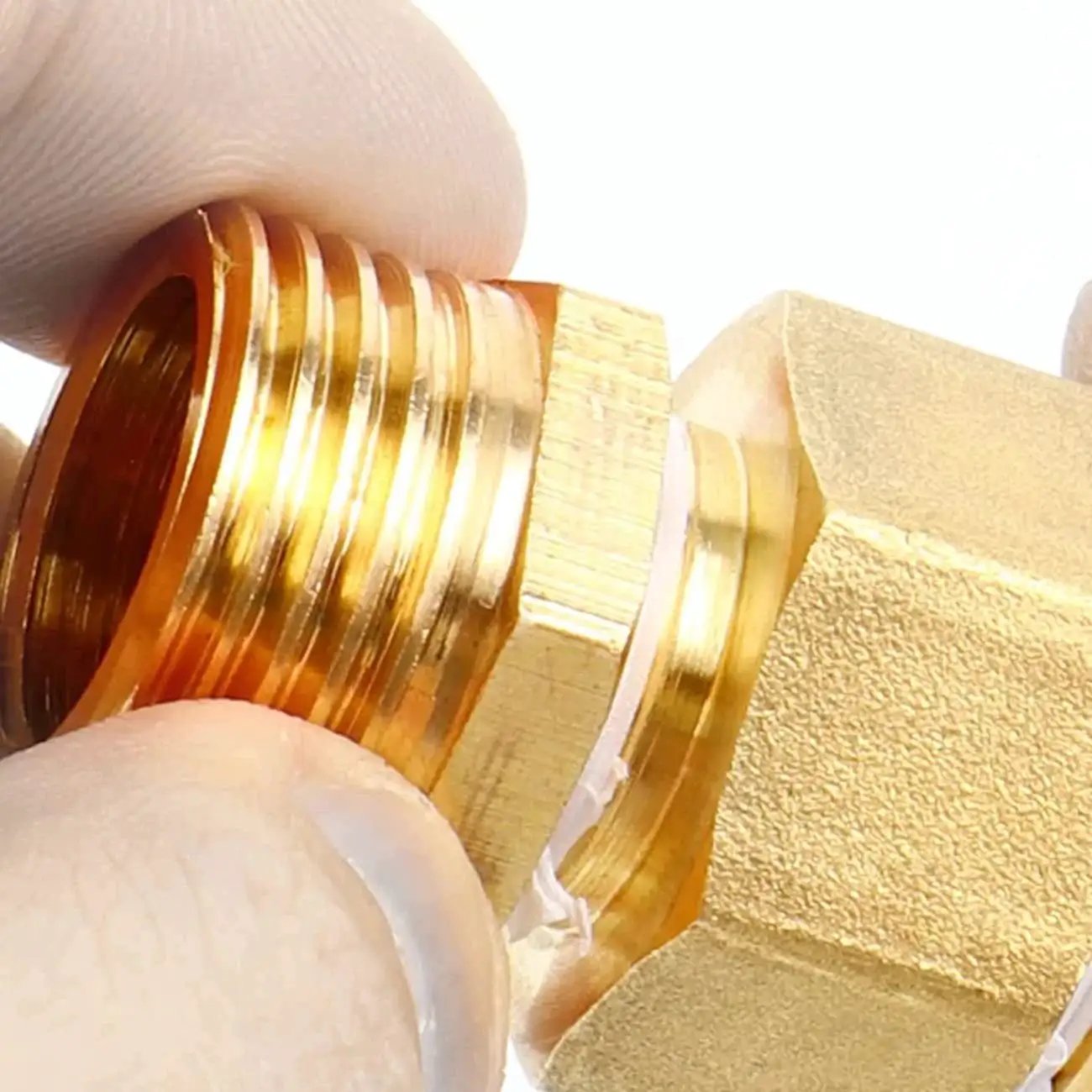 Close-up of Two Pack Brass Bushing Reducer Adapter One Half Inch NPT Male To One Quarter Inch NPT Female Pipe Fittings, durable brass.