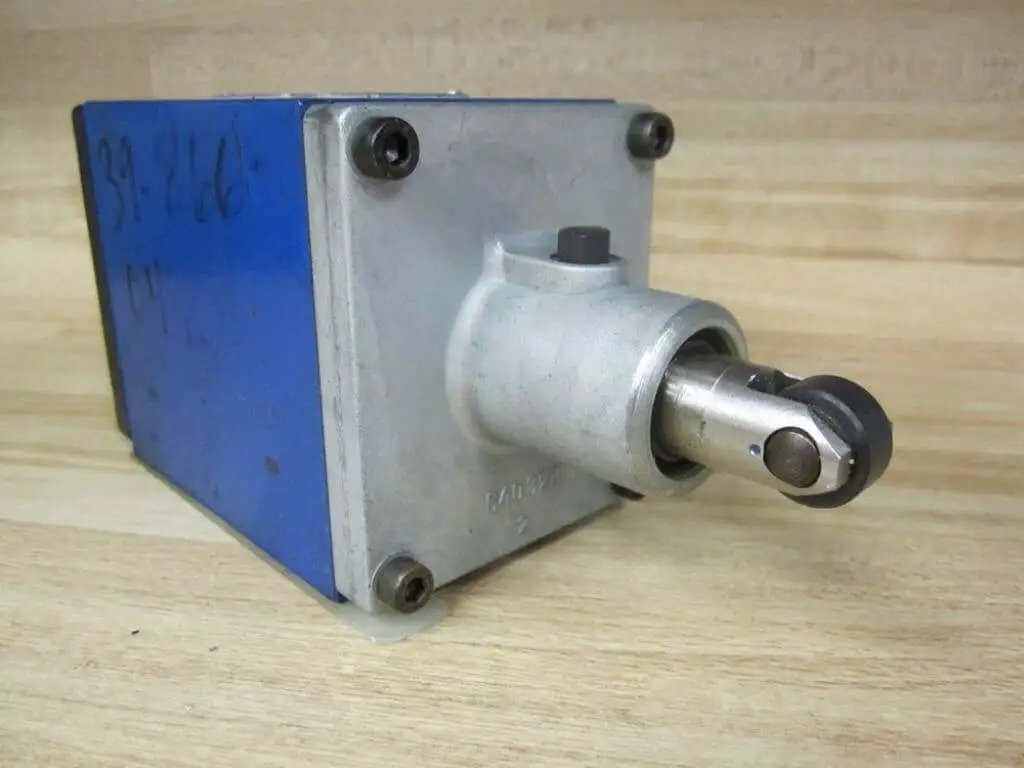 Bosch Rexroth R900590253 Hydraulic Valve 4WMU10D31 with limit switch roller, angled view showing roller mechanism on wooden surface.