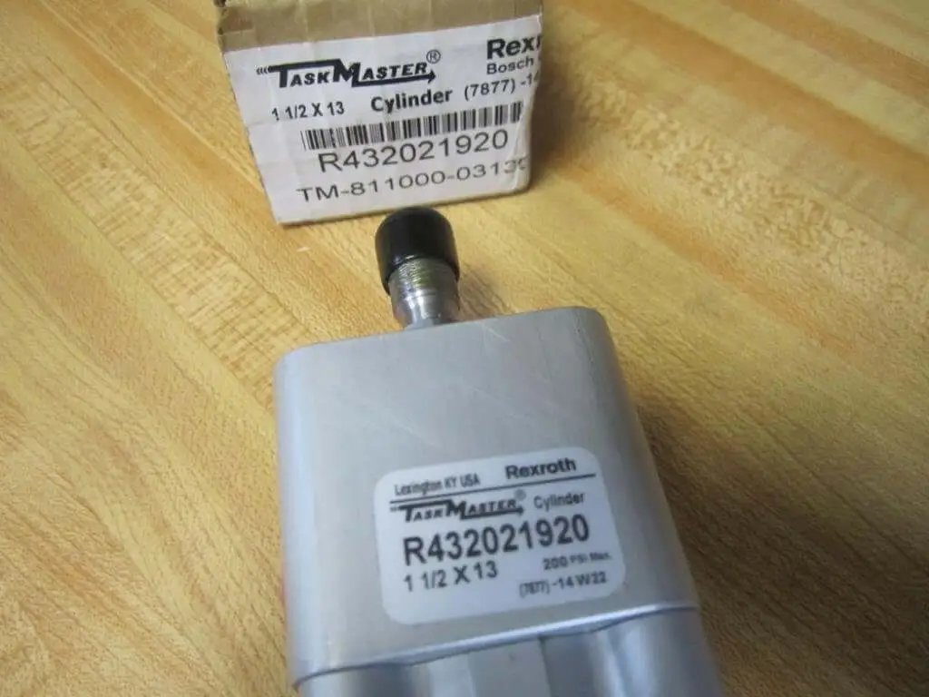Close-up of Rexroth Bosch TM-811000-03130 Pneumatic Cylinder on wooden surface, showing label and 1/4 inch ports.