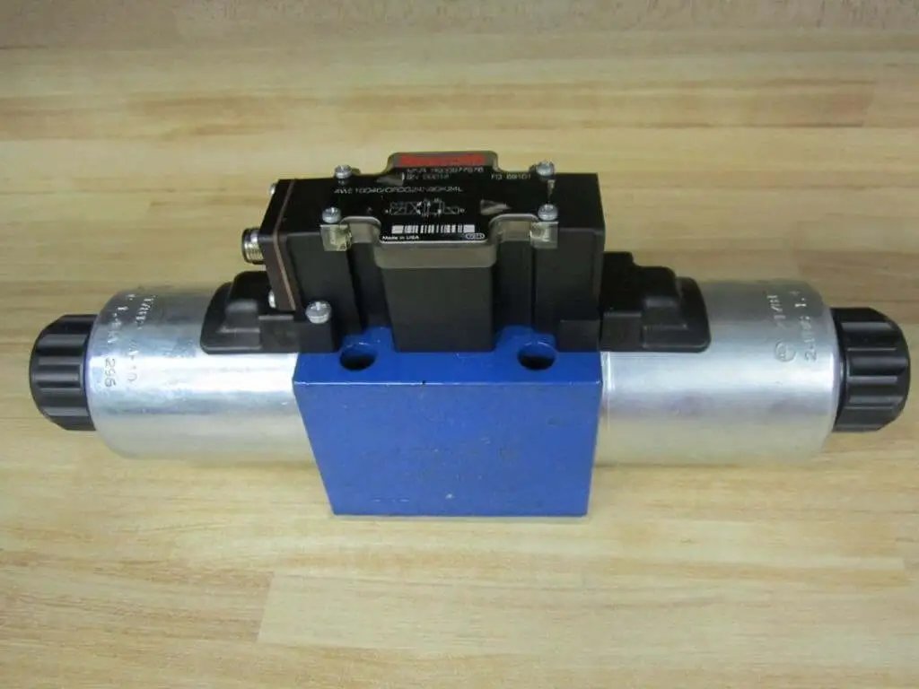 Hydraulic Solenoid Directional Control Valve 4WE10D40/OFCG24N9DK24L with 24VDC Coil and 4-Pin Male Connector on wood surface