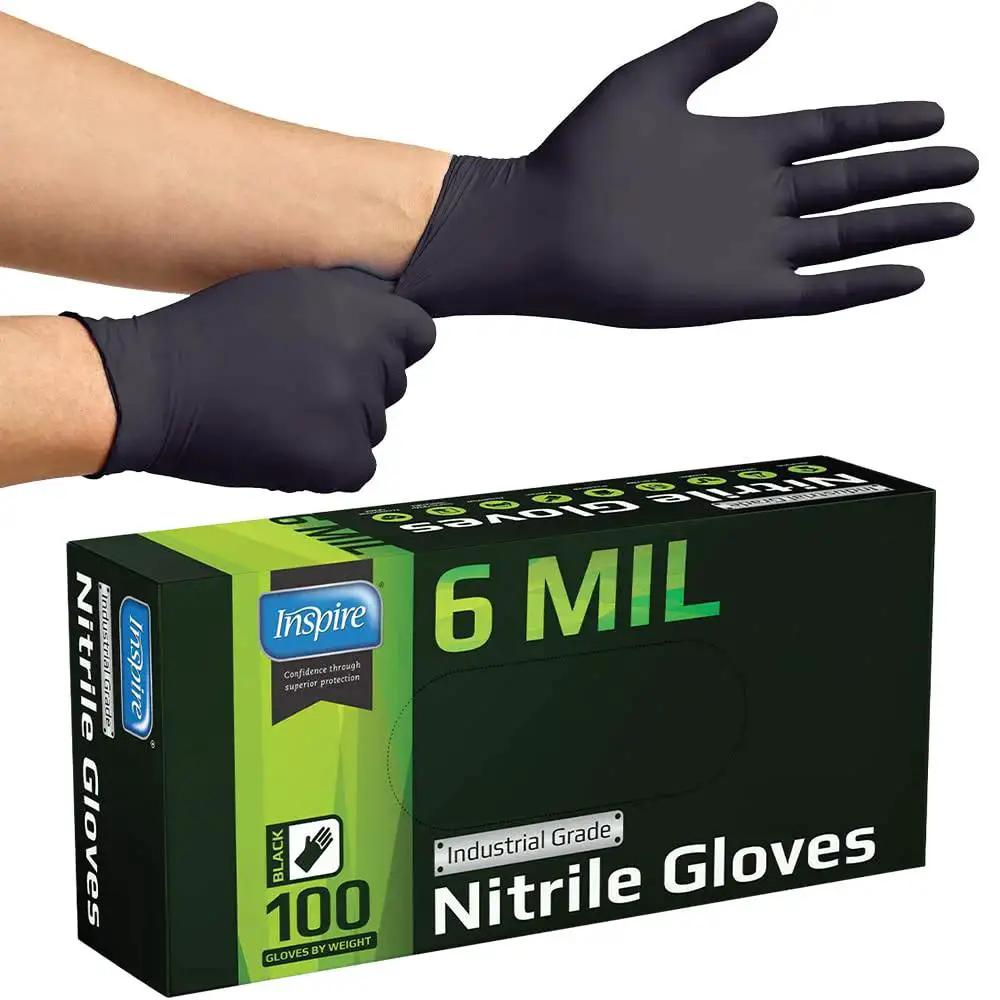 Person wearing Heavy Duty 6 Mil Black Nitrile Gloves latex free for industrial food tattoo, with box showing 100 gloves per pack.