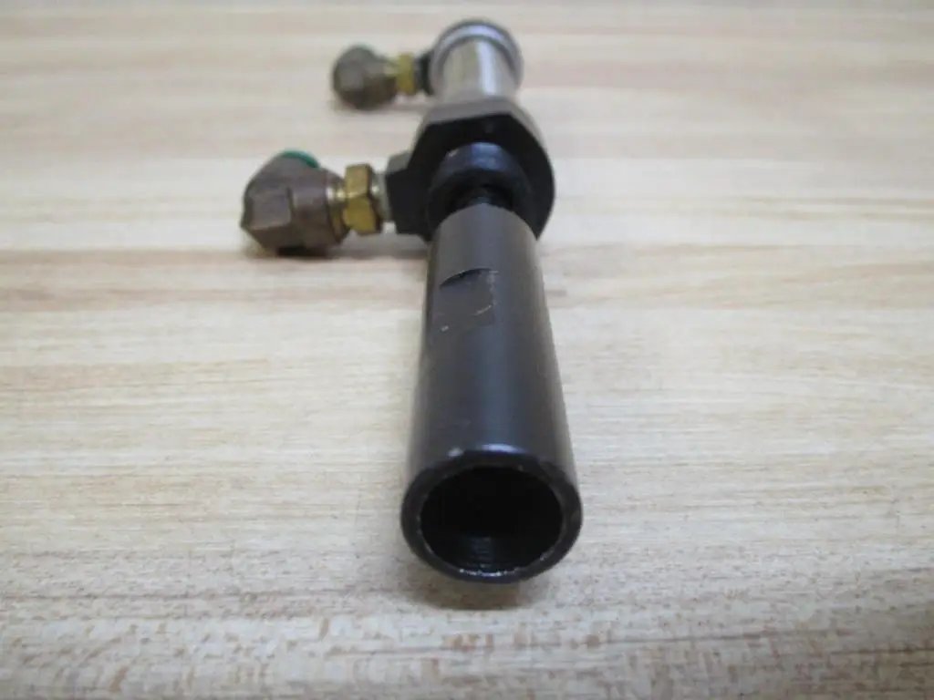 Industrial Hydraulic Cylinder 10mm Bore With Two And One Half Inches Stroke PN 13316050001 close-up side view on wooden surface.