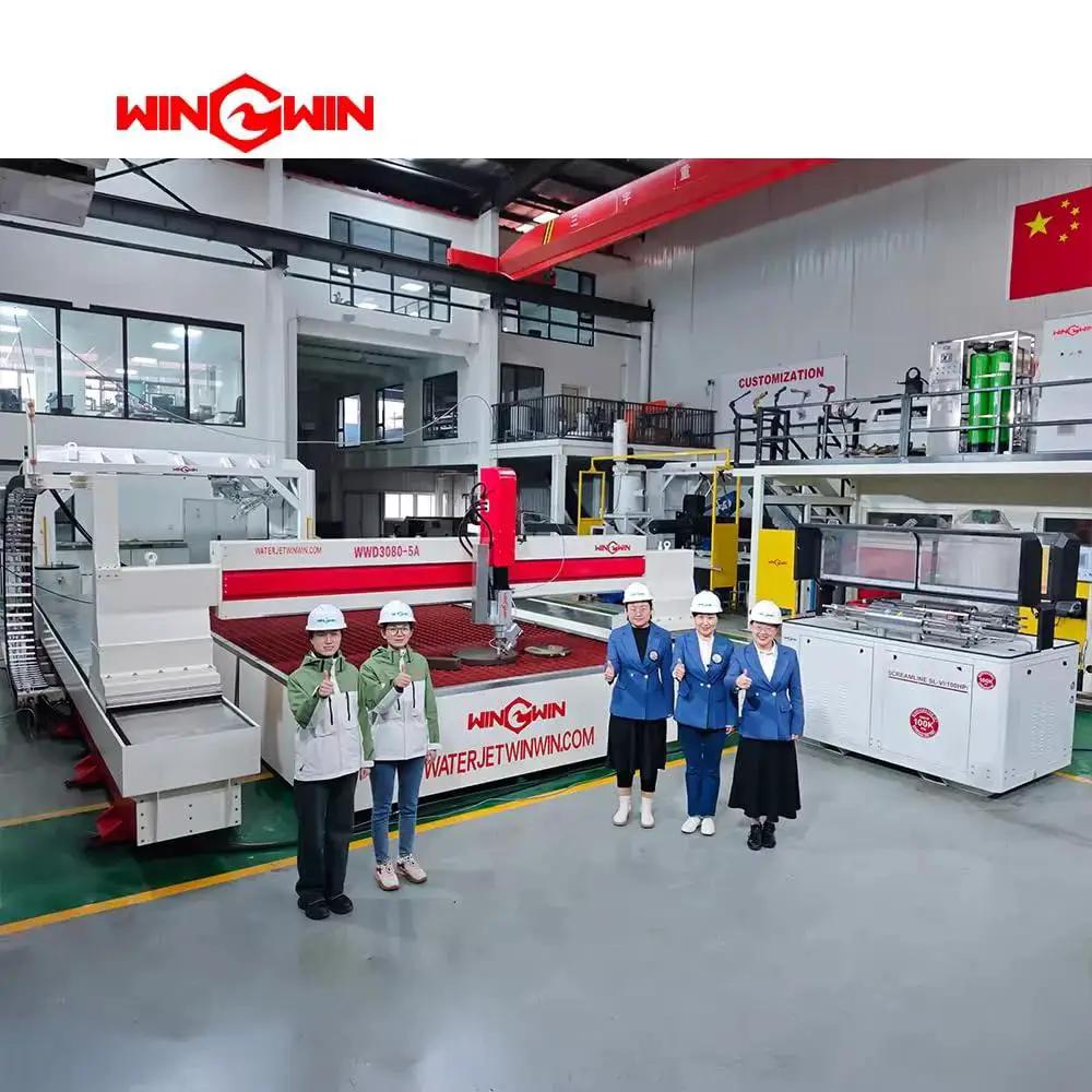 Facility interior with waterjet cutting machines and five people wearing safety helmets