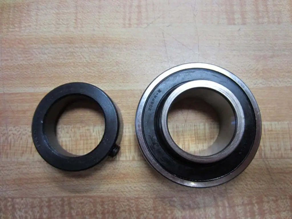 Single KH206-30 Narrow Inner-Ring Eccentric Collar 30 mm bearing insert and locking sleeve on wood surface
