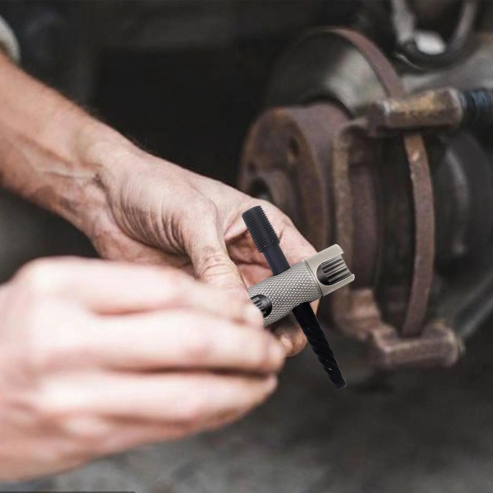 Person using multi-tool from Grease Fitting Replacement Kit SAE And Metric With One Quarter Inch And One Eighth Inch Straight And 45 Degree And 90 Degree Zerks Hydraulic Fittings With Plastic Cap Covers 2 Multi Tools 332 Piece Set