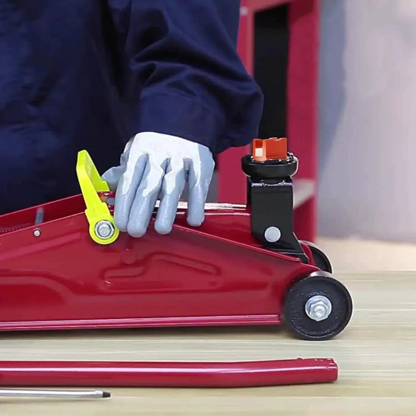Aluminum Grooved Magnetic Jack Pad Pinch Weld Frame Rail Adapter For Cars installed on a red hydraulic jack.