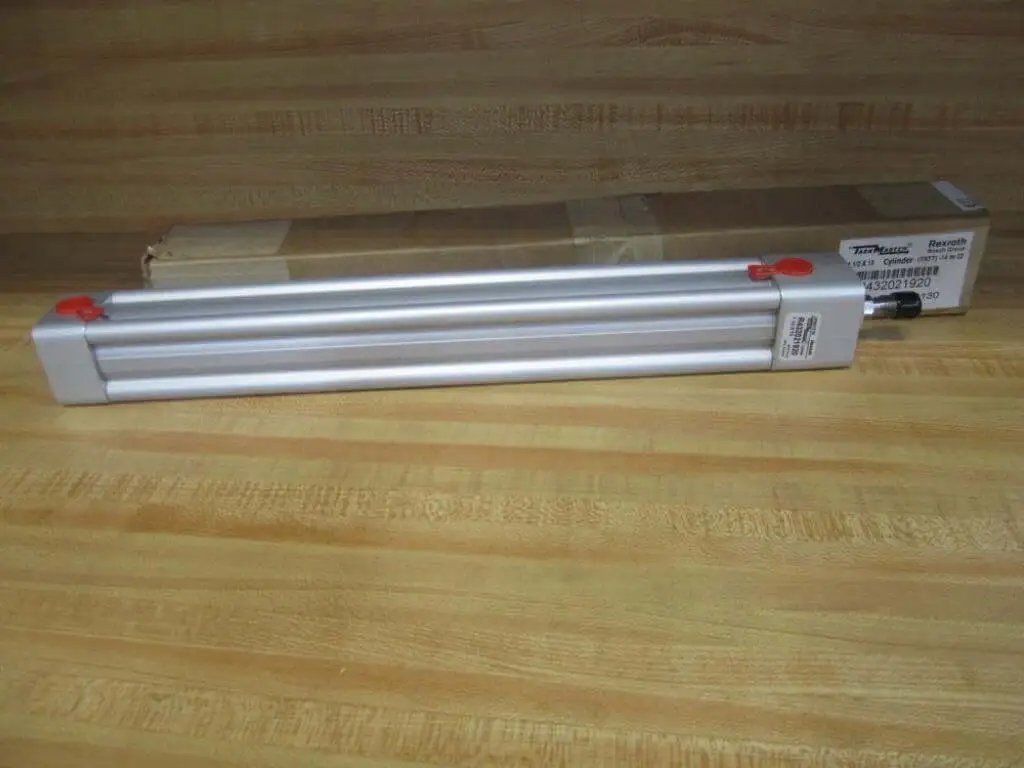 Rexroth Bosch TM-811000-03130 Pneumatic Cylinder, 12.5 inch stroke, 17 inch body, displayed with packaging on wooden surface