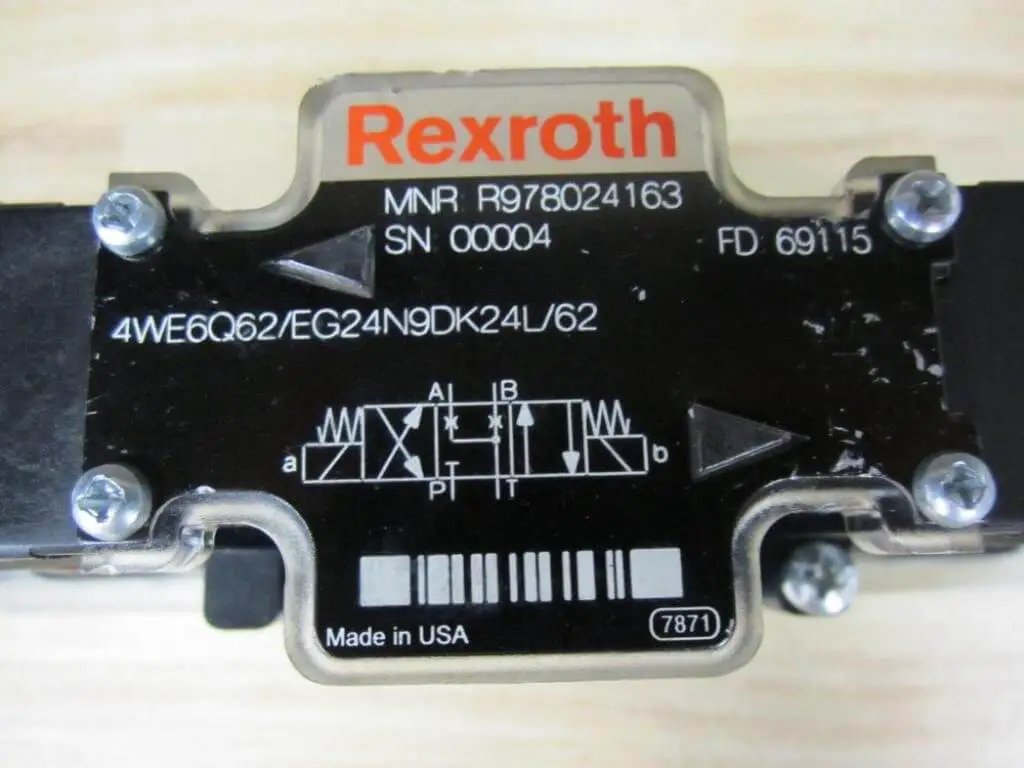 Close-up of solenoid directional valve R978024163 4WE6Q62/EG24N9DK24L/62 label with Bosch Rexroth branding and technical specifications.