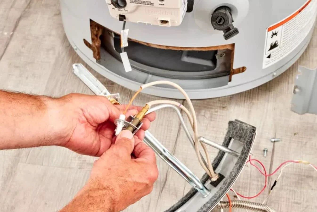 Person installing Replacement 30 Inch Thermocouple For Gas Furnaces Boilers And Water Heaters Compatible With Honeywell Home CQ100A1039