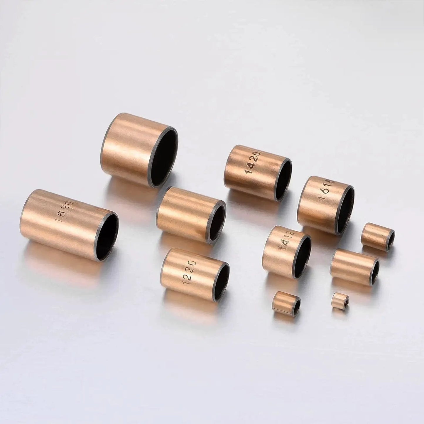 3mm Bore 5mm OD 5mm Length Sleeve Bearings Set Of 10 Oil Free Bronze Sintered Bushings for sliding parts arranged on a reflective surface
