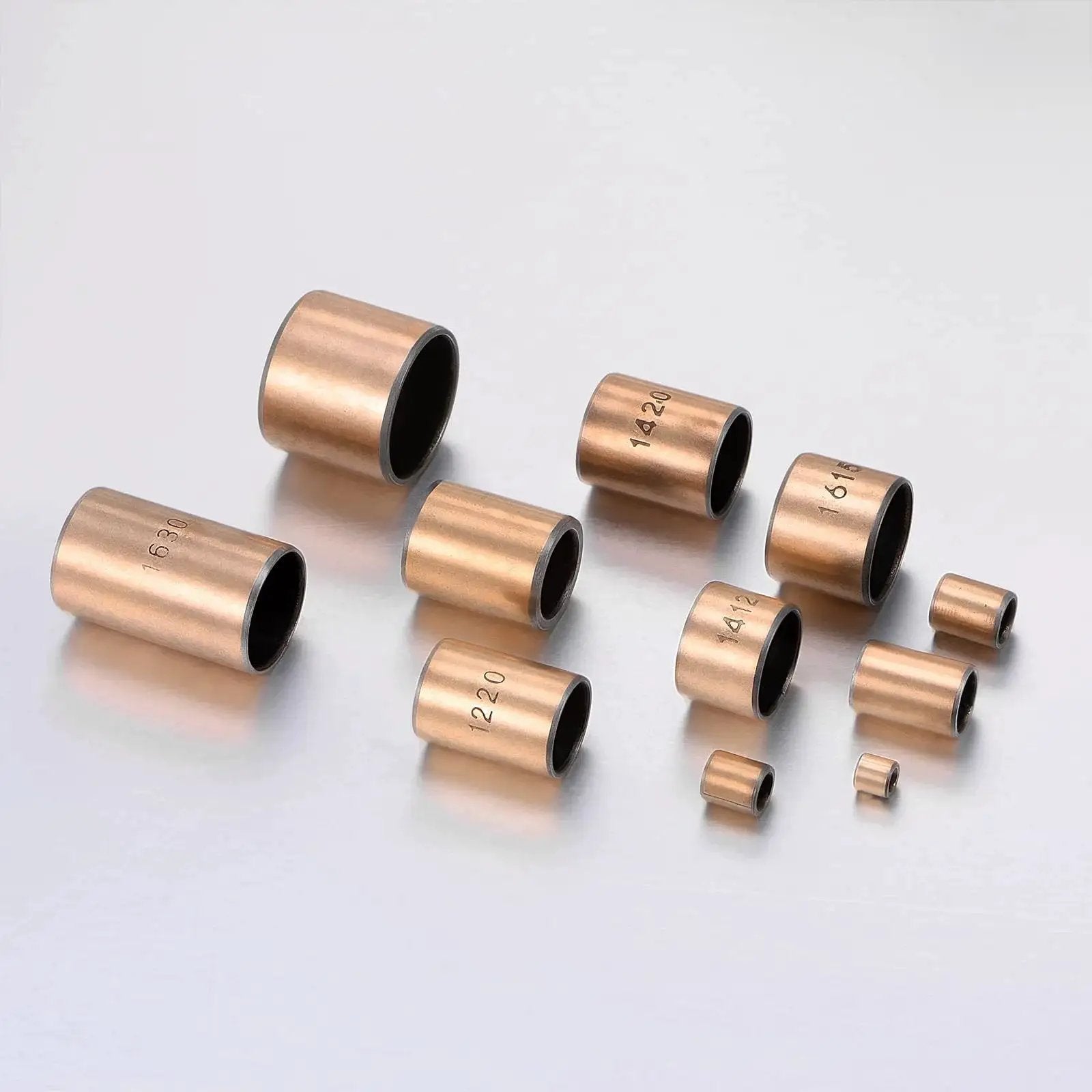 3mm Bore 5mm OD 5mm Length Sleeve Bearings Set Of 10 Oil Free Bronze Sintered Bushings for sliding parts arranged on a reflective surface