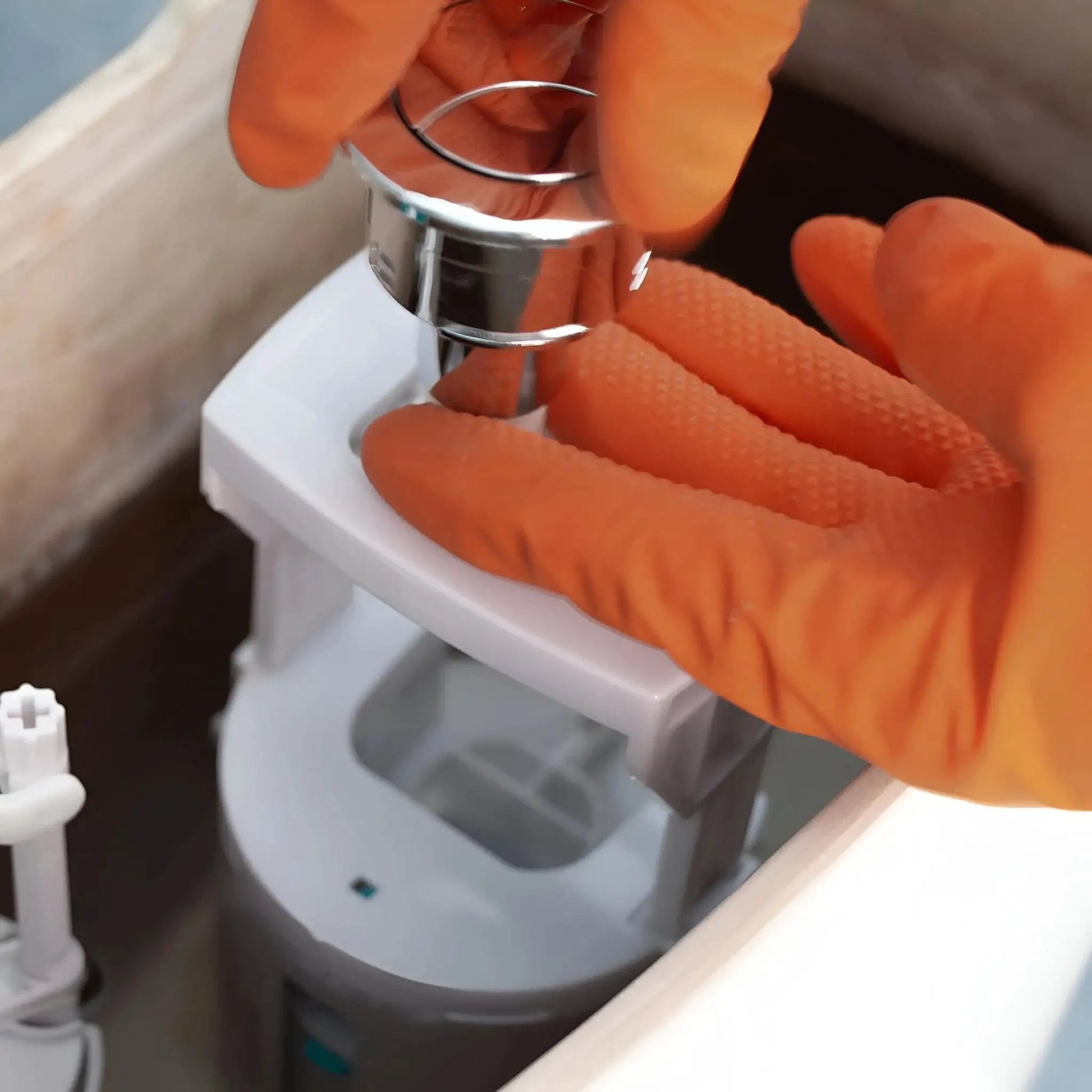 Person wearing Heavy Duty Nitrile Gloves 8 Mil Diamond Grip Latex Free Orange XXL 100 Count adjusting a metal component