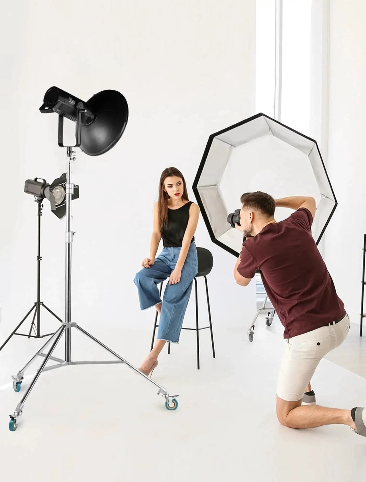 Photographer setting up in studio with professional light stand wheels set 0.9 inch 22mm diameter swivel casters for photography stands
