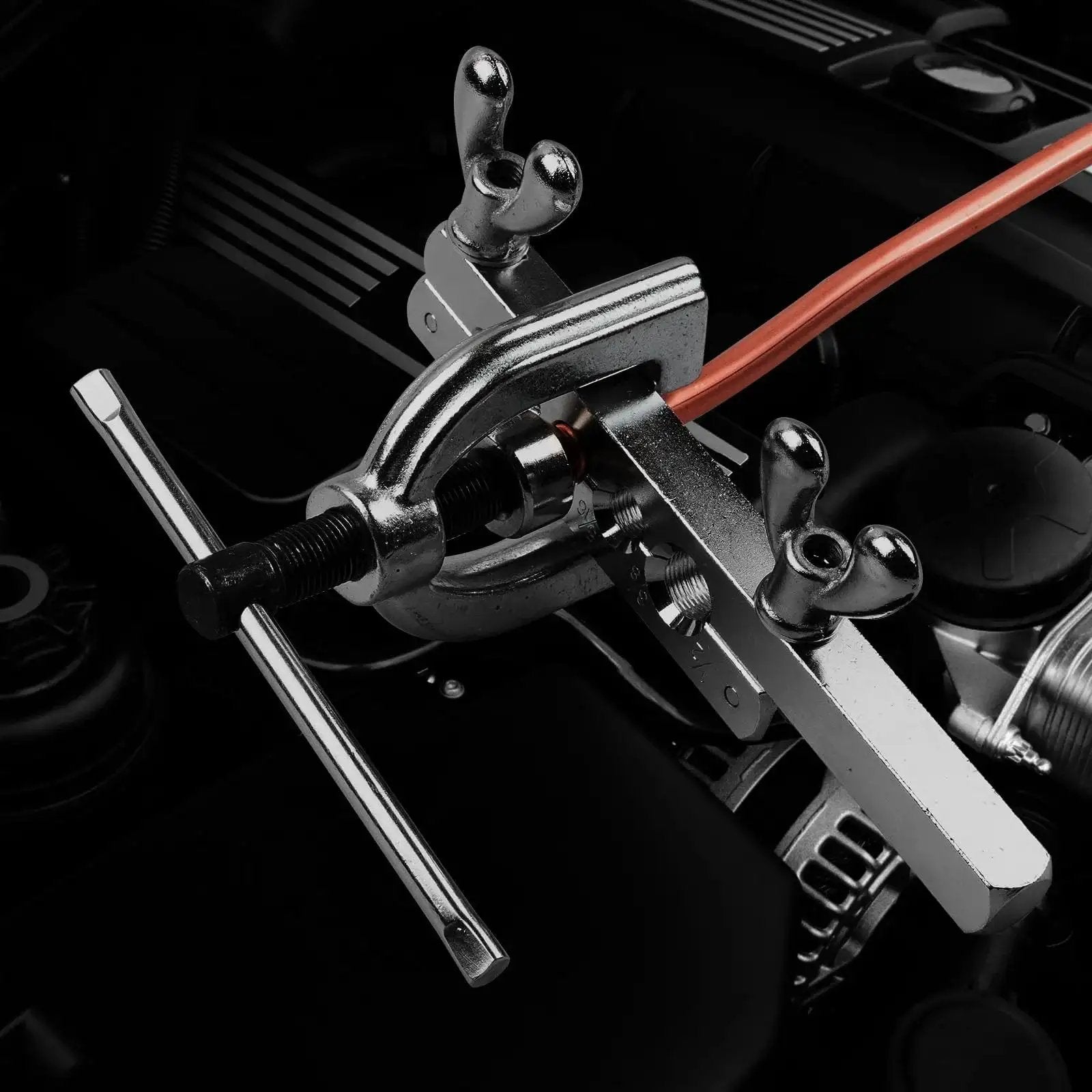 Close-up of Brake Line Flare Tool Kit With Tubing Cutter and 5 Adapters for Copper Tubing in use on an automotive brake line.