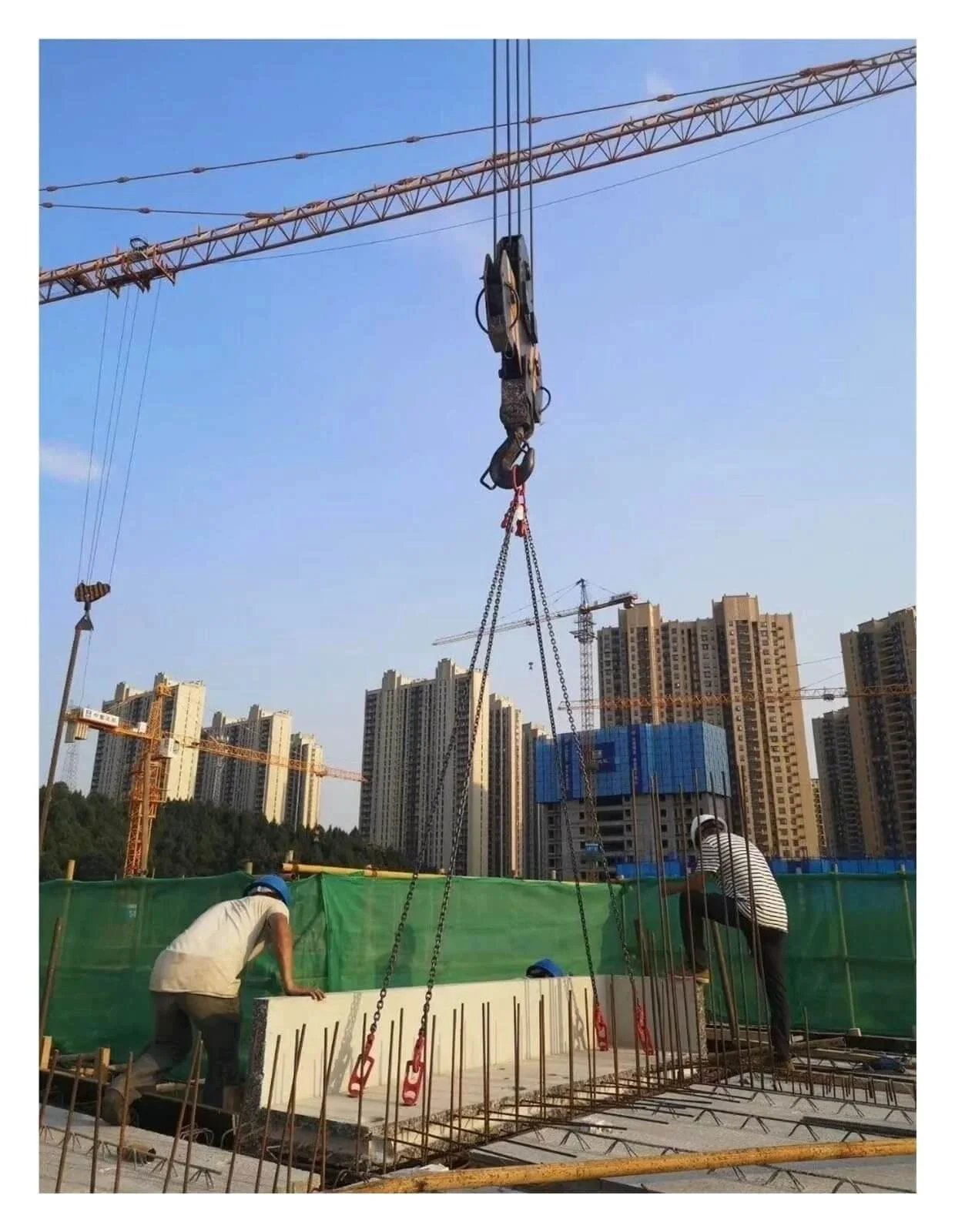 Precast Concrete Lifting Clutch With Steel Lifting Ring lifting panel on construction site with cranes and workers visible