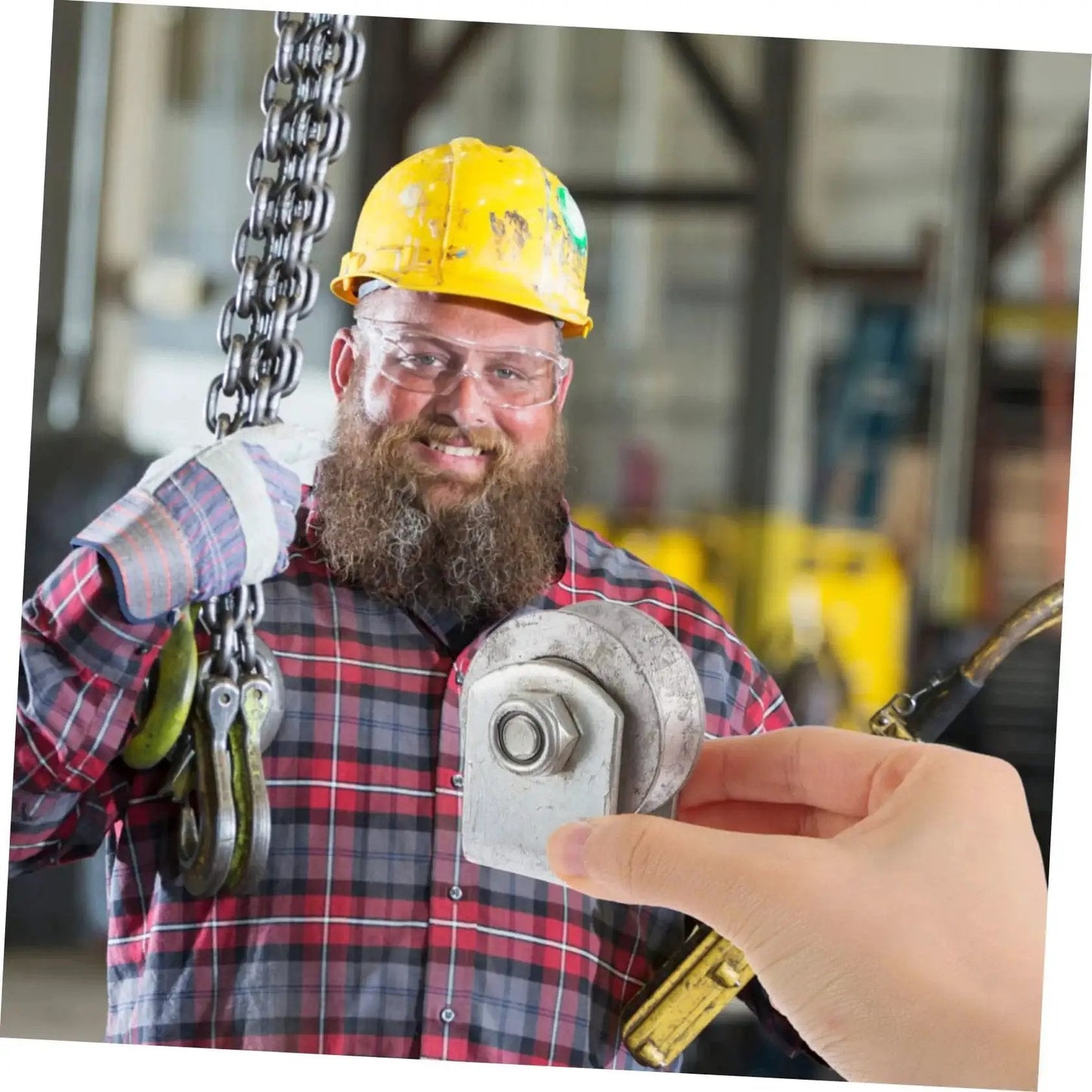 Person in hard hat holding chain hoist, hand showing Heavy Duty Cast Iron V Groove Wheel For Garage Doors And Sliding Gates With Swivel Caster Bracket.