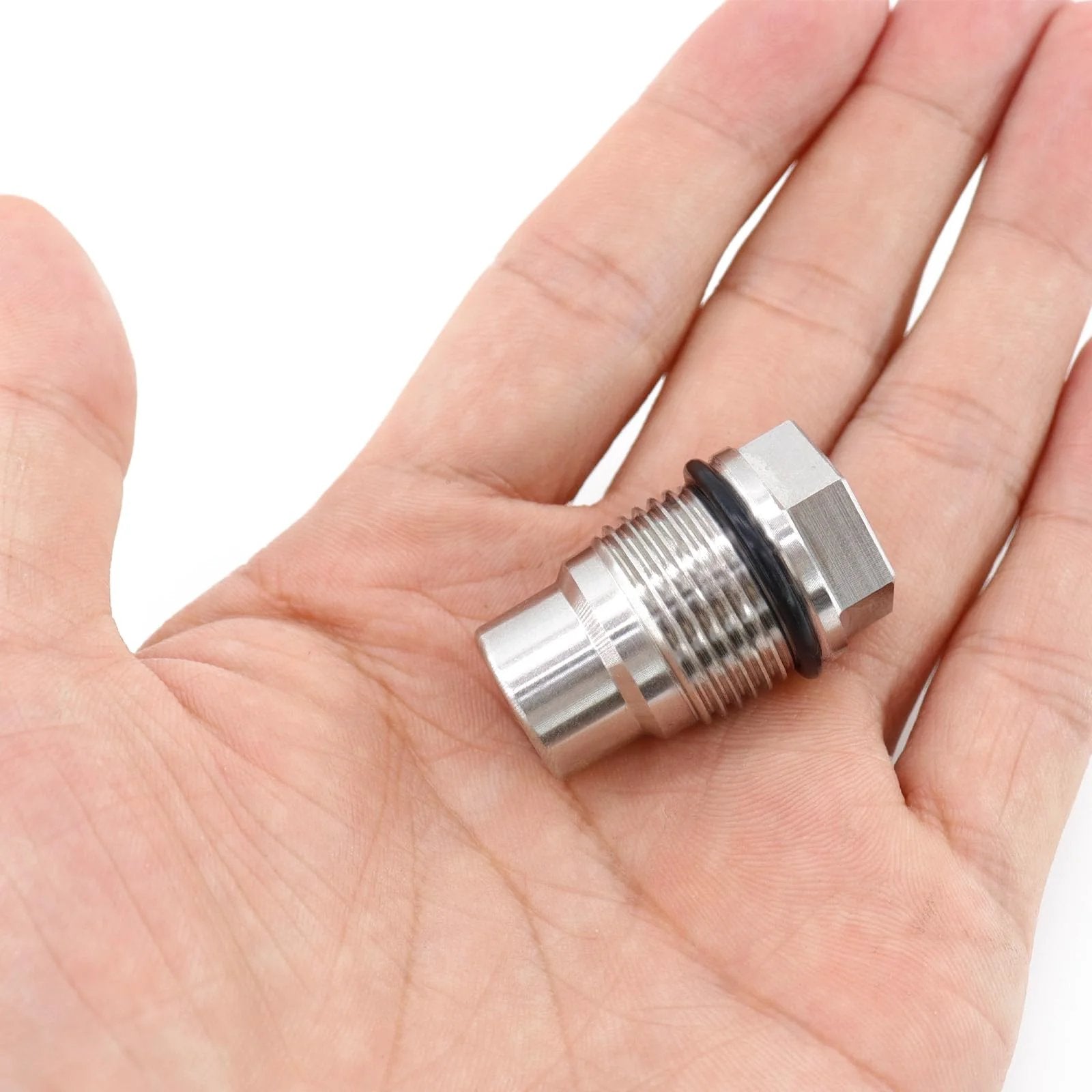 Hand holding Stainless Steel Diesel Fuel Rail Plug Valve M20x1.5 Direct Replacement For Chevy GMC Duramax 6.6L 2005 To 2010 And Dodge Ram Cummins 6.7L
