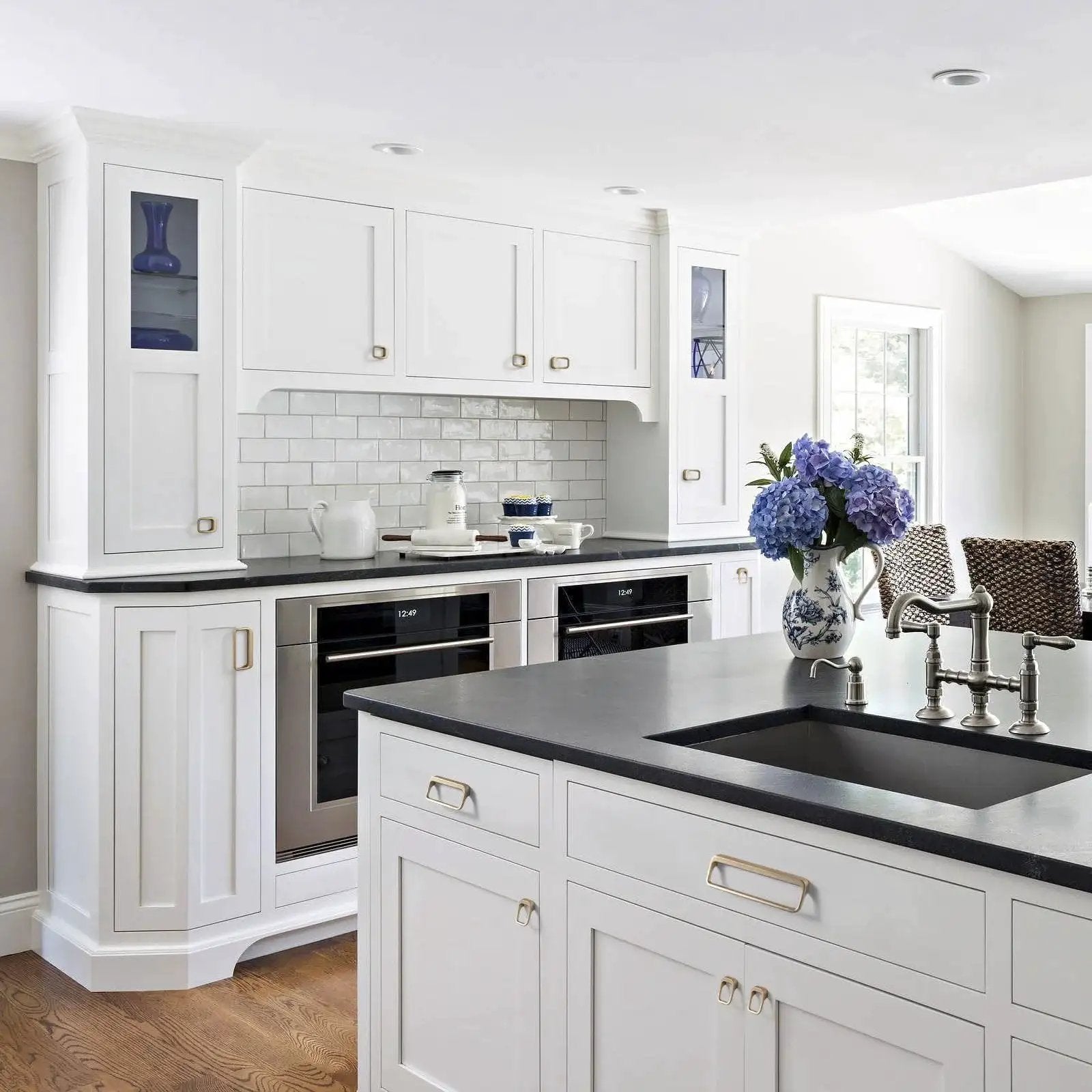 Modern white kitchen with Champagne Bronze Cabinet Pulls With Center Hole 5 Inch Length Modern Zinc Finger Handles on cabinets.