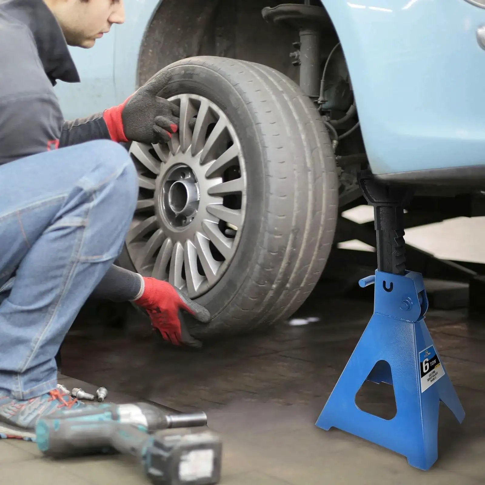 Mechanic using 6 Ton Adjustable Jack Stands Heavy Duty Steel Lifting Stand 14.6 To 24 Inches under vehicle