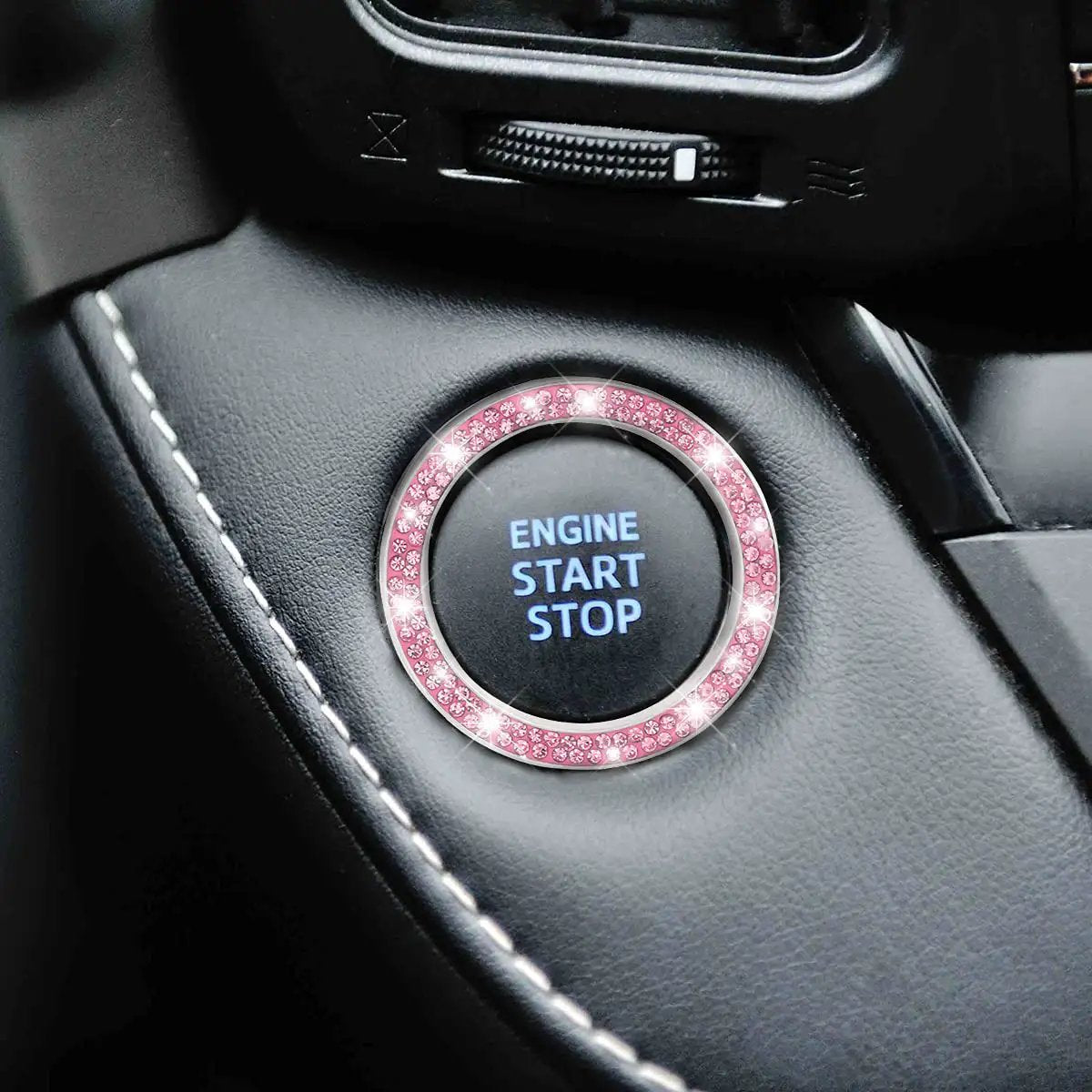 Close-up of installed Pink Car Start Button Bling Ring Set 2 Pack Crystal Rhinestone Decals on an engine start button.