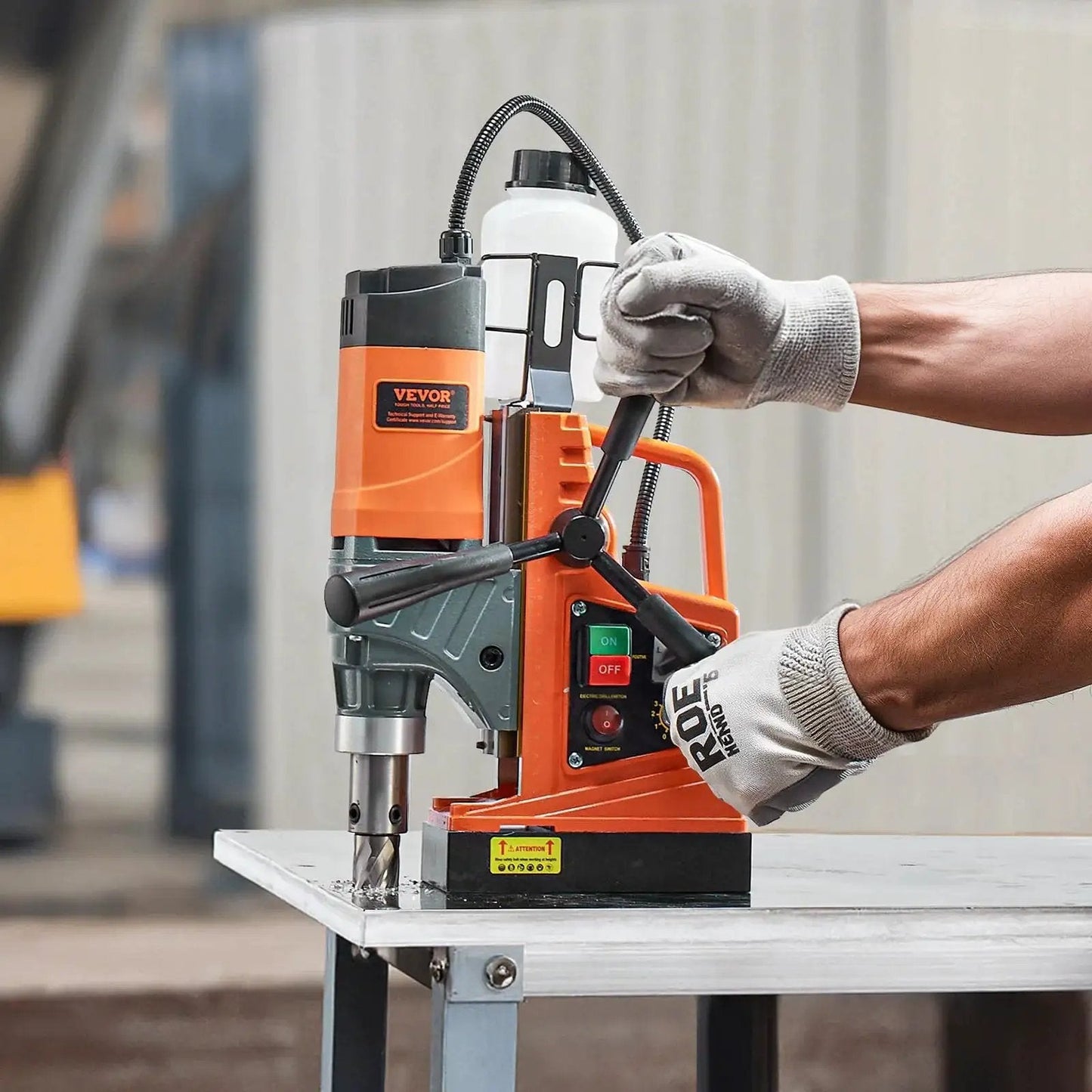 Person using a Heavy Duty Magnetic Drill Press With 1450W Motor, 0-800 RPM, 2 In Boring Capacity, Portable Electric Mag Drill by VEVOR.