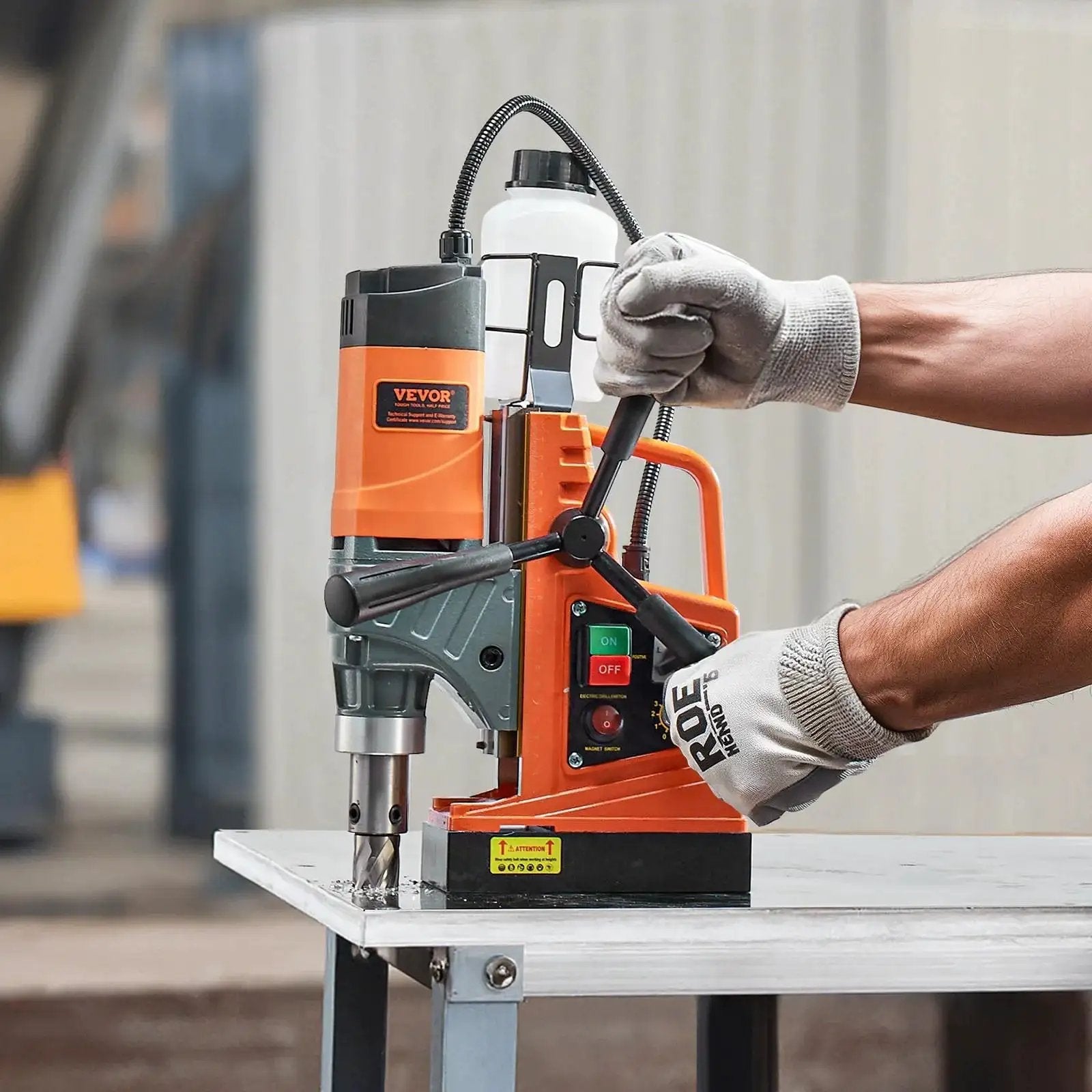 Person using a Heavy Duty Magnetic Drill Press With 1450W Motor, 0-800 RPM, 2 In Boring Capacity, Portable Electric Mag Drill by VEVOR.