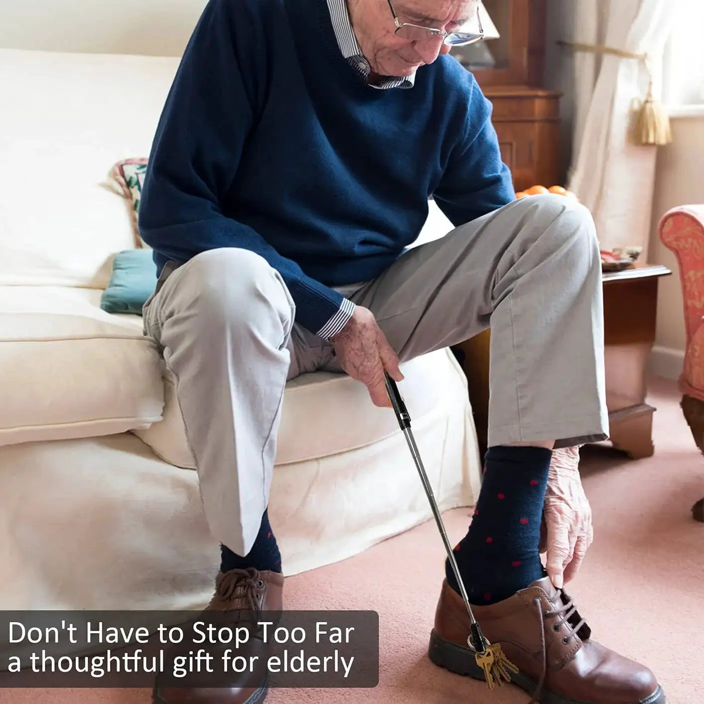 Man using a shoehorn while sitting on a sofa, demonstrating ease for elderly. Gift idea for elderly individuals.