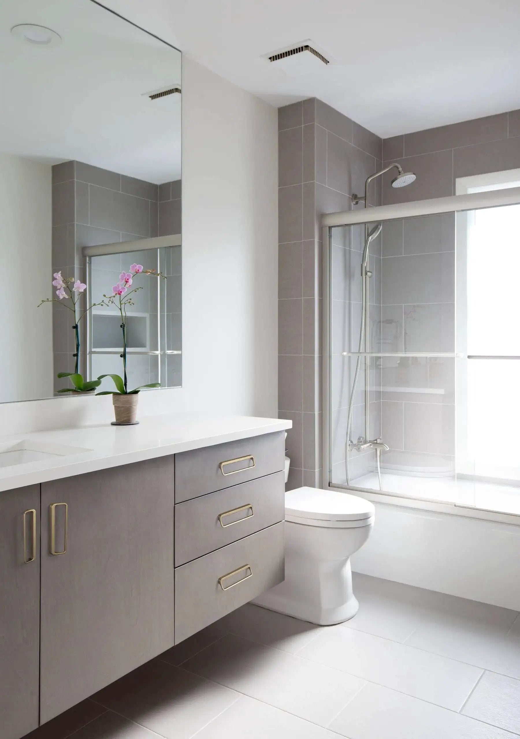 Modern bathroom with gray cabinets featuring Champagne Bronze Cabinet Pulls With Center Hole 5 Inch Length for drawers and cupboards.