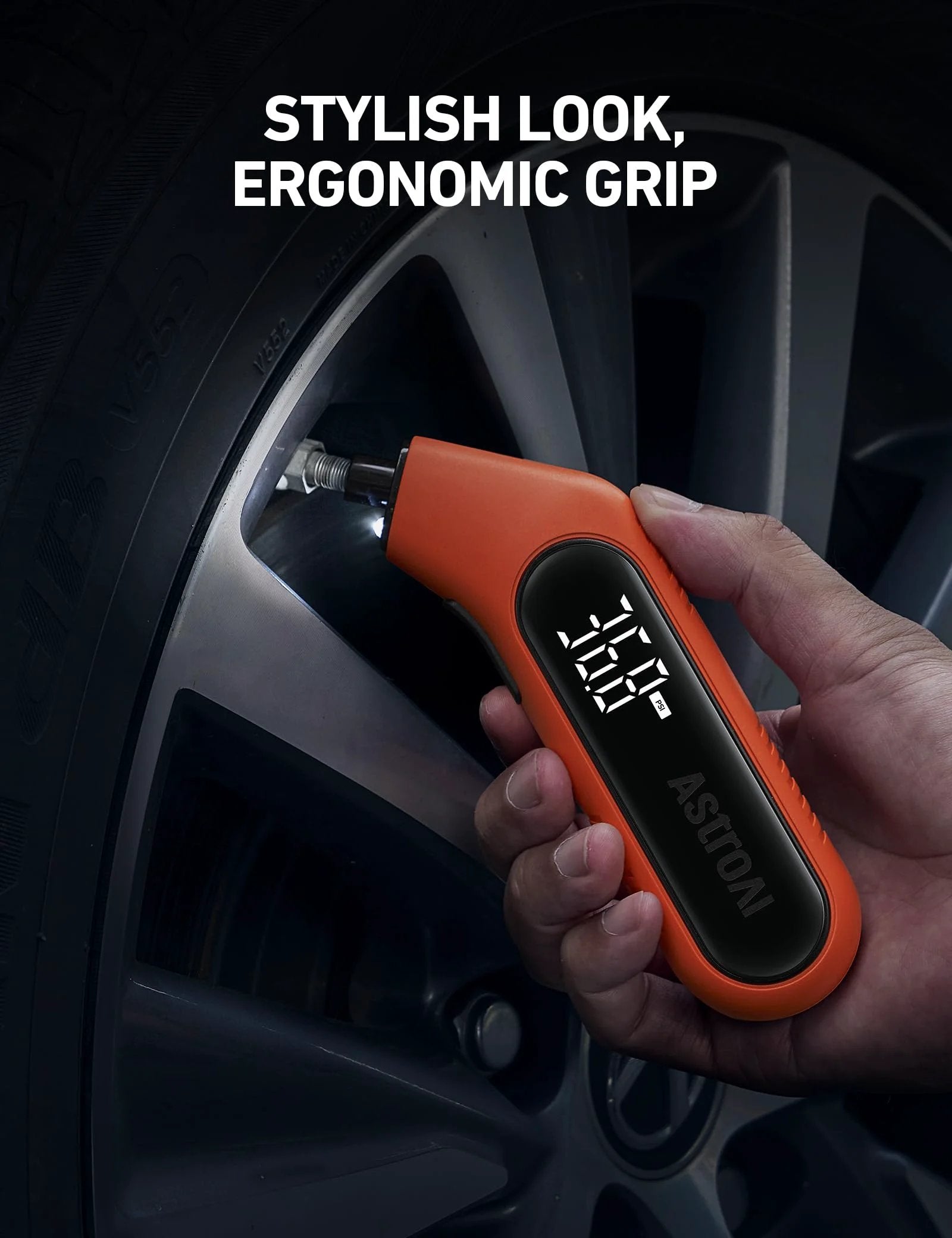 Hand holding Digital Tire Pressure Gauge 3-300 PSI with Backlit Display and Flashlight, Orange AstroAI, checking car tire pressure.