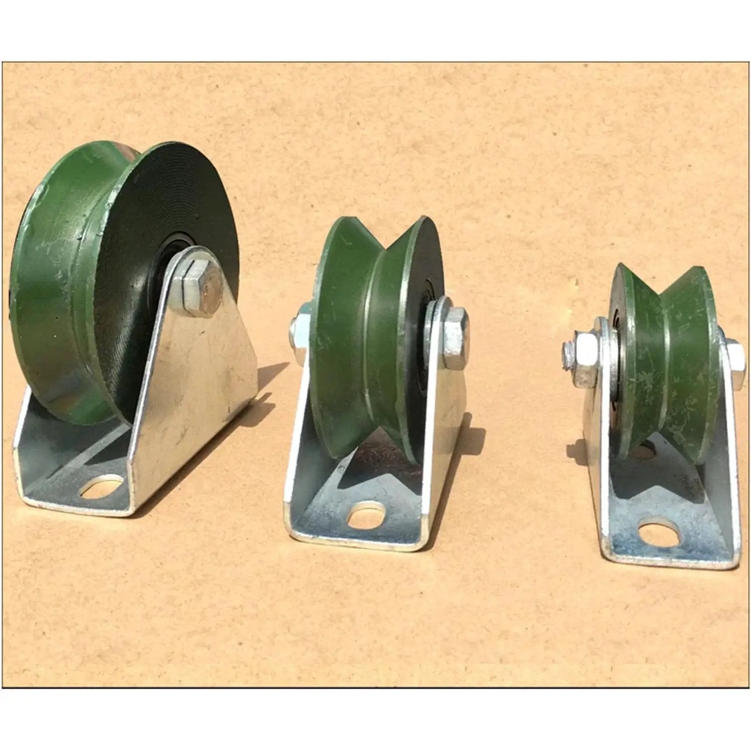 Three varying sizes of V Groove Pulley Wheel For Sliding Gates And Wire Rope Rail, heavy duty, 2.2 inch cast iron, on a beige background.