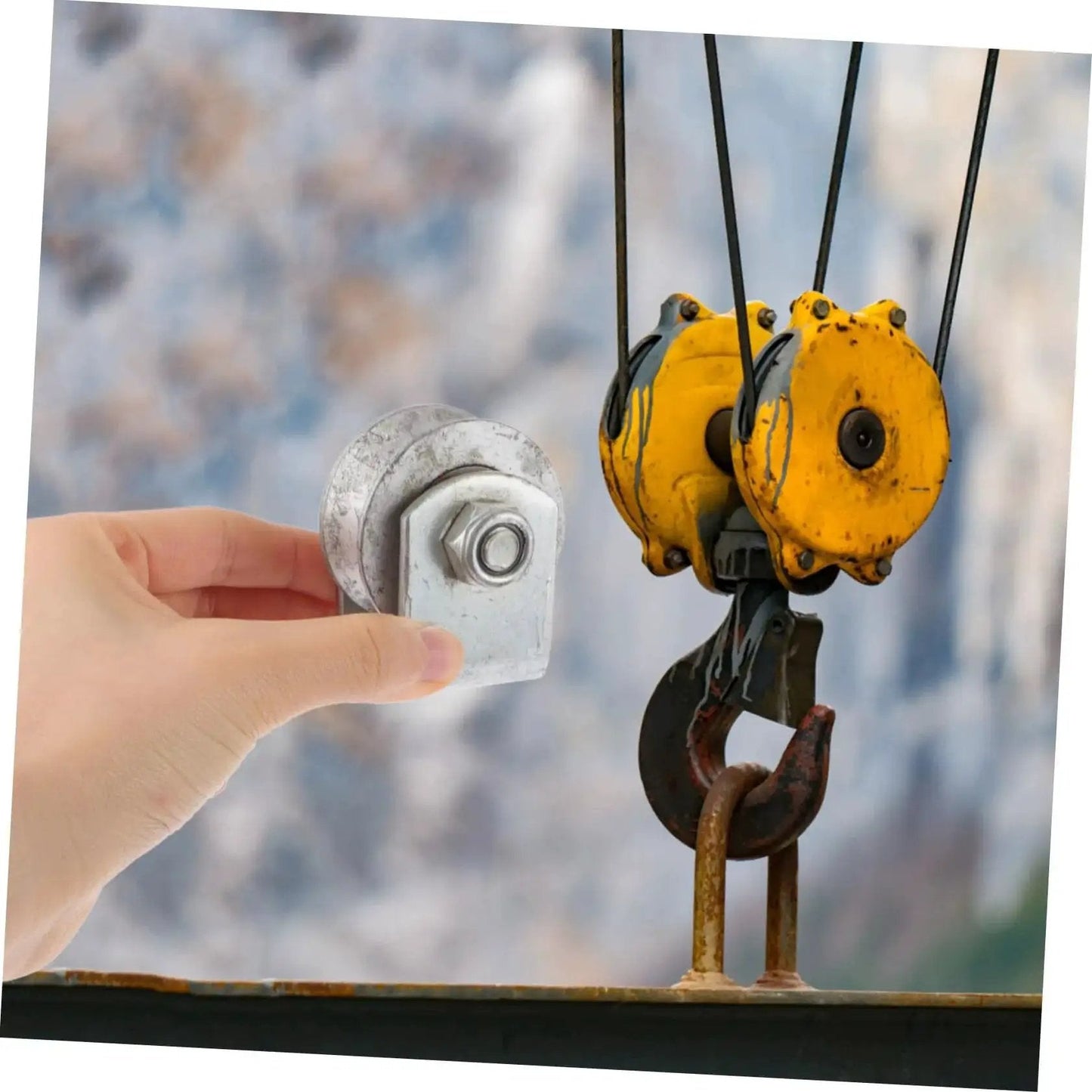 Rugged Cast Iron V Type Groove Wheel Garage Door Roller for Gates and Sliding Doors shown next to industrial pulley