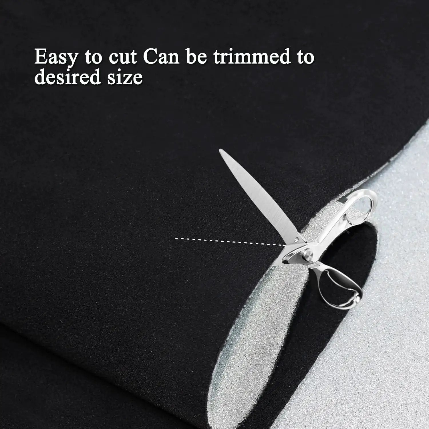 Close-up of Suede Headliner Fabric With Foam Backing For Car Interior Black 96x60 being cut with scissors.