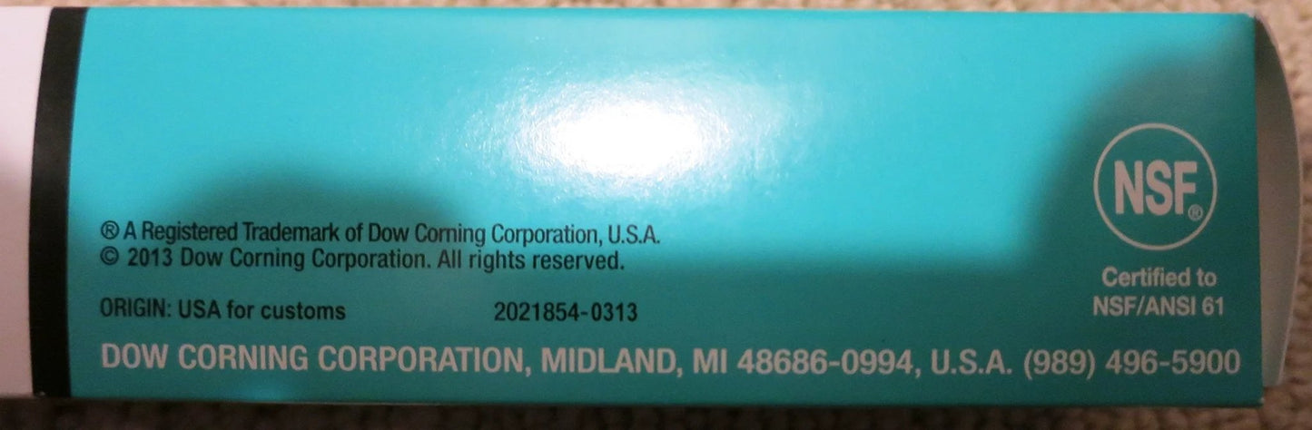 Side view of Dow Corning Pro Grade Silicone Vacuum Lubricant tube showing certification and company details.