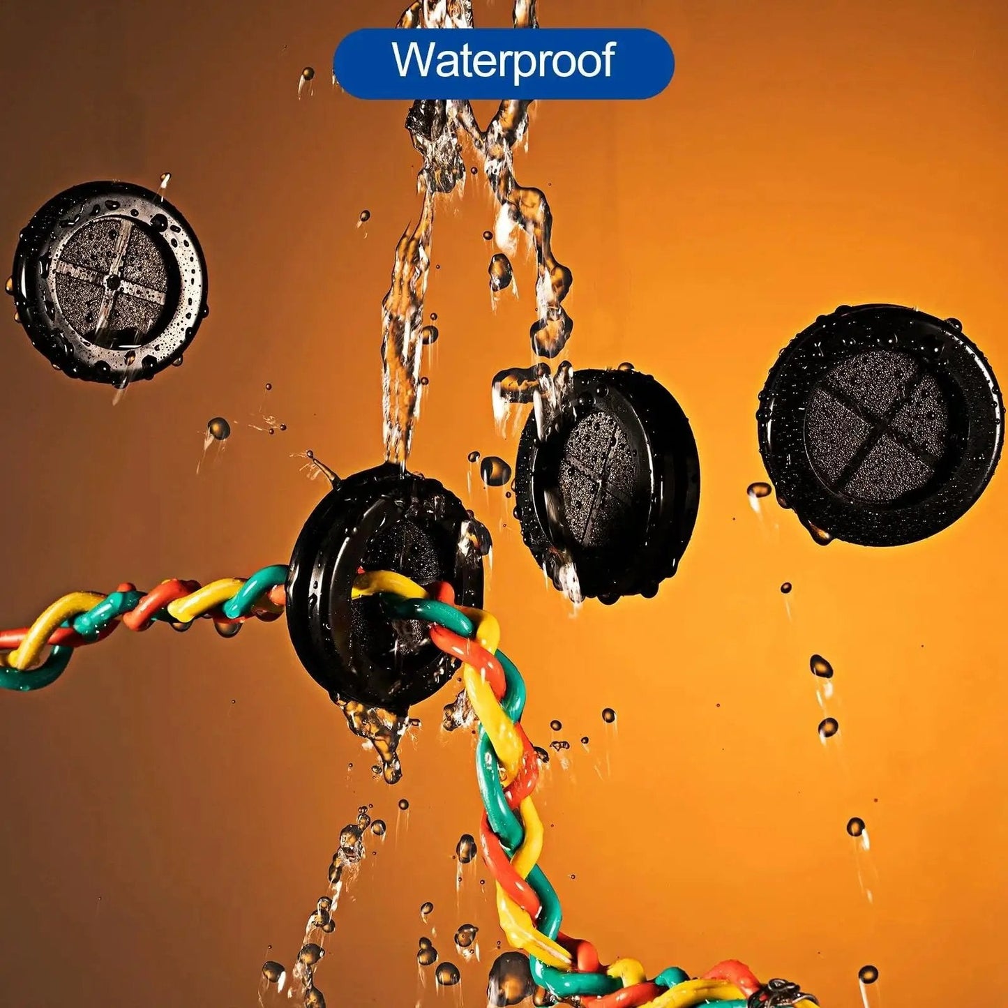 Waterproof Set Of Four Rubber Grommets For Firewall Cable Protection with wires, black, shown under water spray.