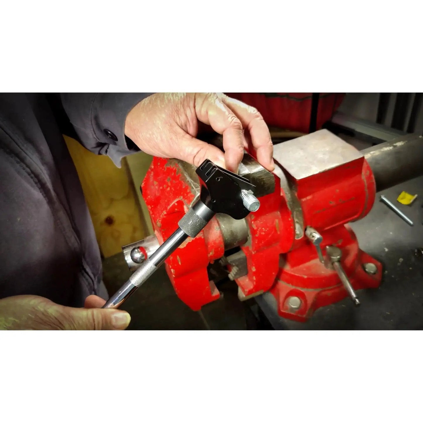 Universal Thread Repair Tool For SAE And Metric Threads With Adjustable Pitch being used on a metal vise for repair work
