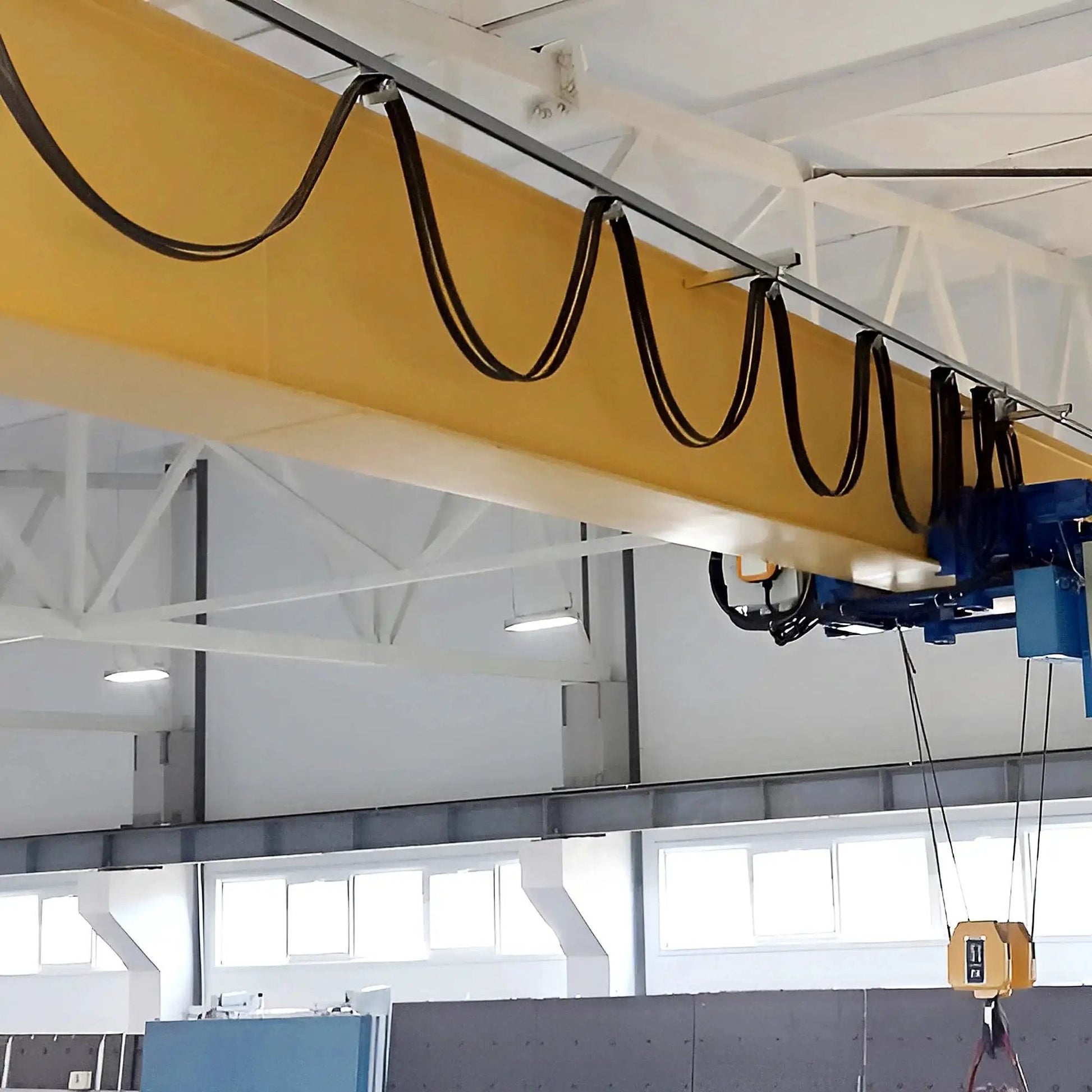 Four Wheel Cable Trolley System installed on a strut channel in a warehouse, showcasing smooth operation for safe lifting.