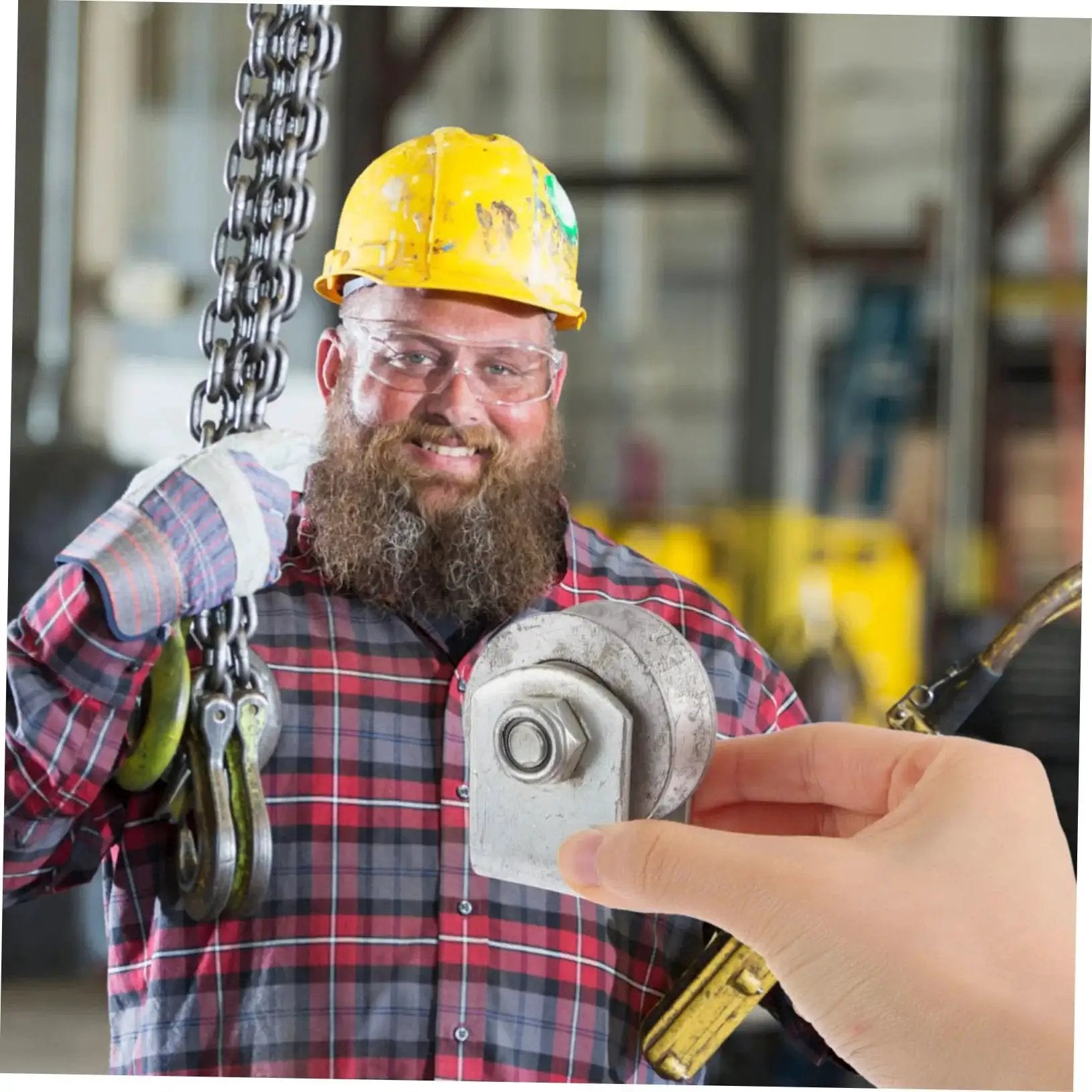 Worker in yellow helmet holding Industrial Cast Iron Groove Wheel Garage Door Roller For Caster Bracket With Embedded Steel Bearing