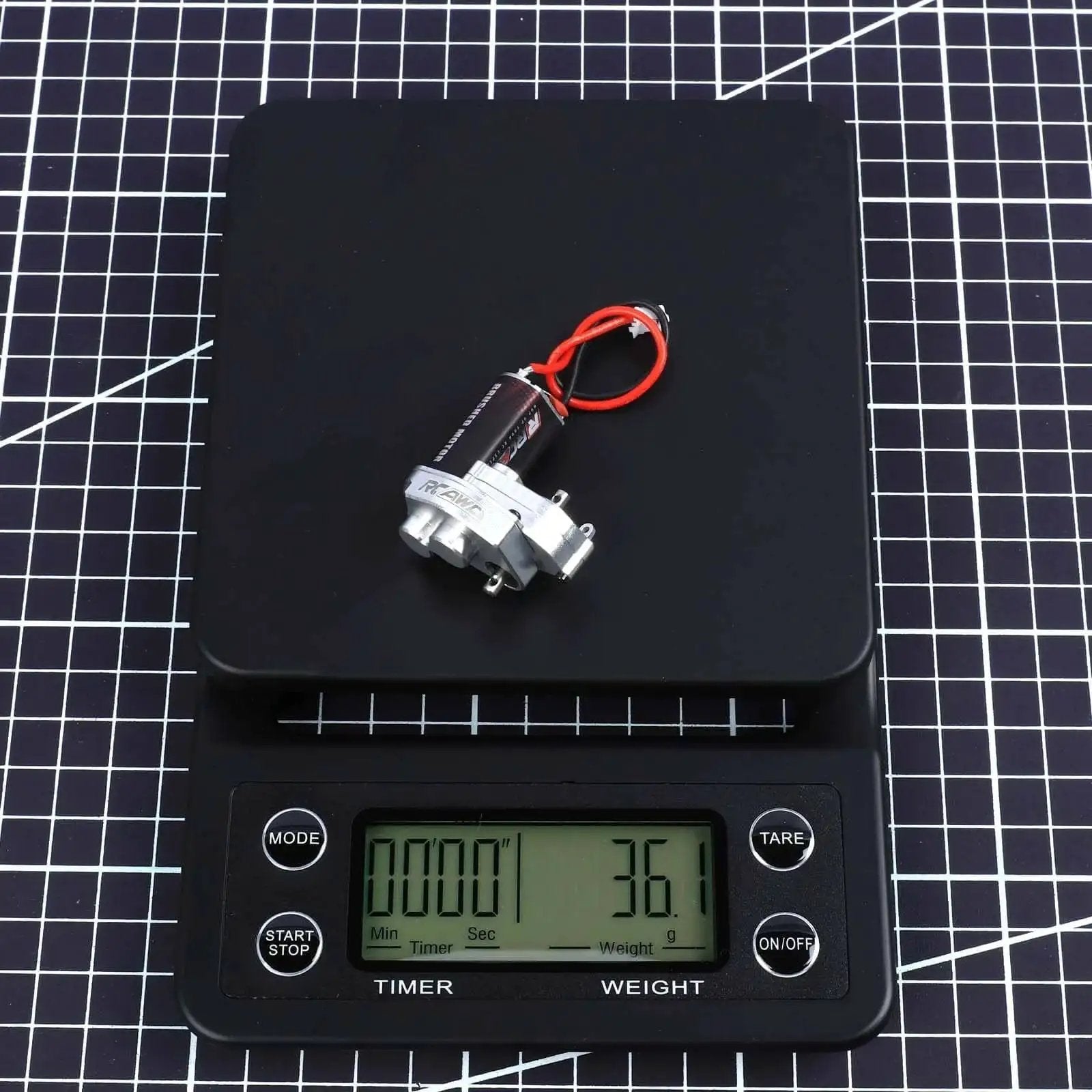Upgraded 55T Carbon Brush 050 Motor With Aluminum Center Gear Case on digital scale showing weight for Axial SCX24 vehicles.