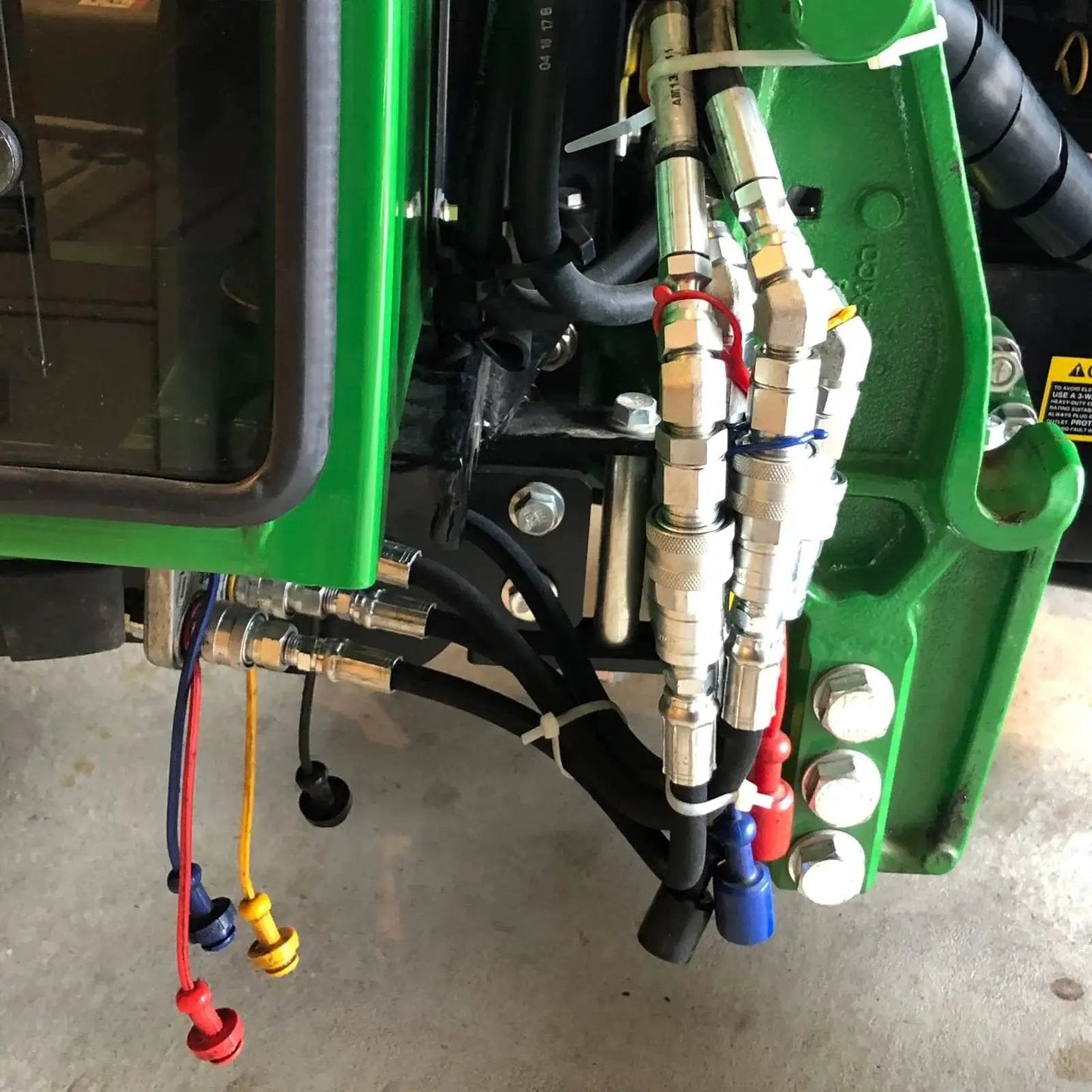 One Quarter Inch Ag ISO 5675 Hydraulic Quick Connect Pioneer Style Couplers installed on machinery with visible dust caps
