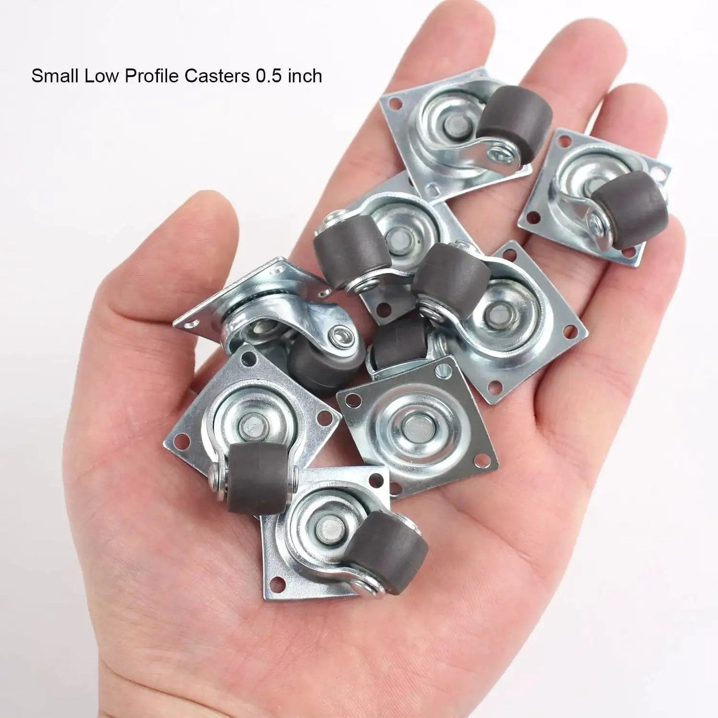 Hand holding eight 0.5 Inch Mini Swivel Caster Wheels with Self Adhesive Plate Low Profile Rubber Casters for Furniture and Small Kitchen Appliances