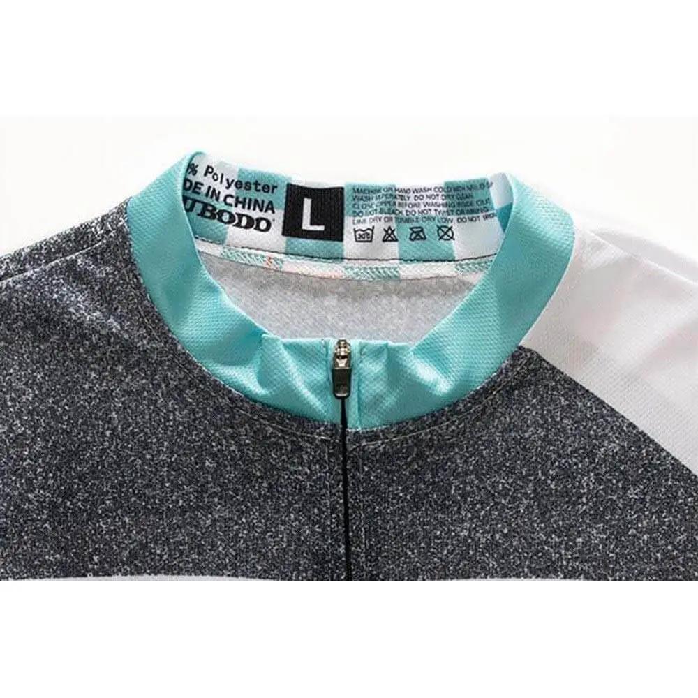 Close-up of a size L black and white sports jacket with turquoise collar detail showing care instructions label.