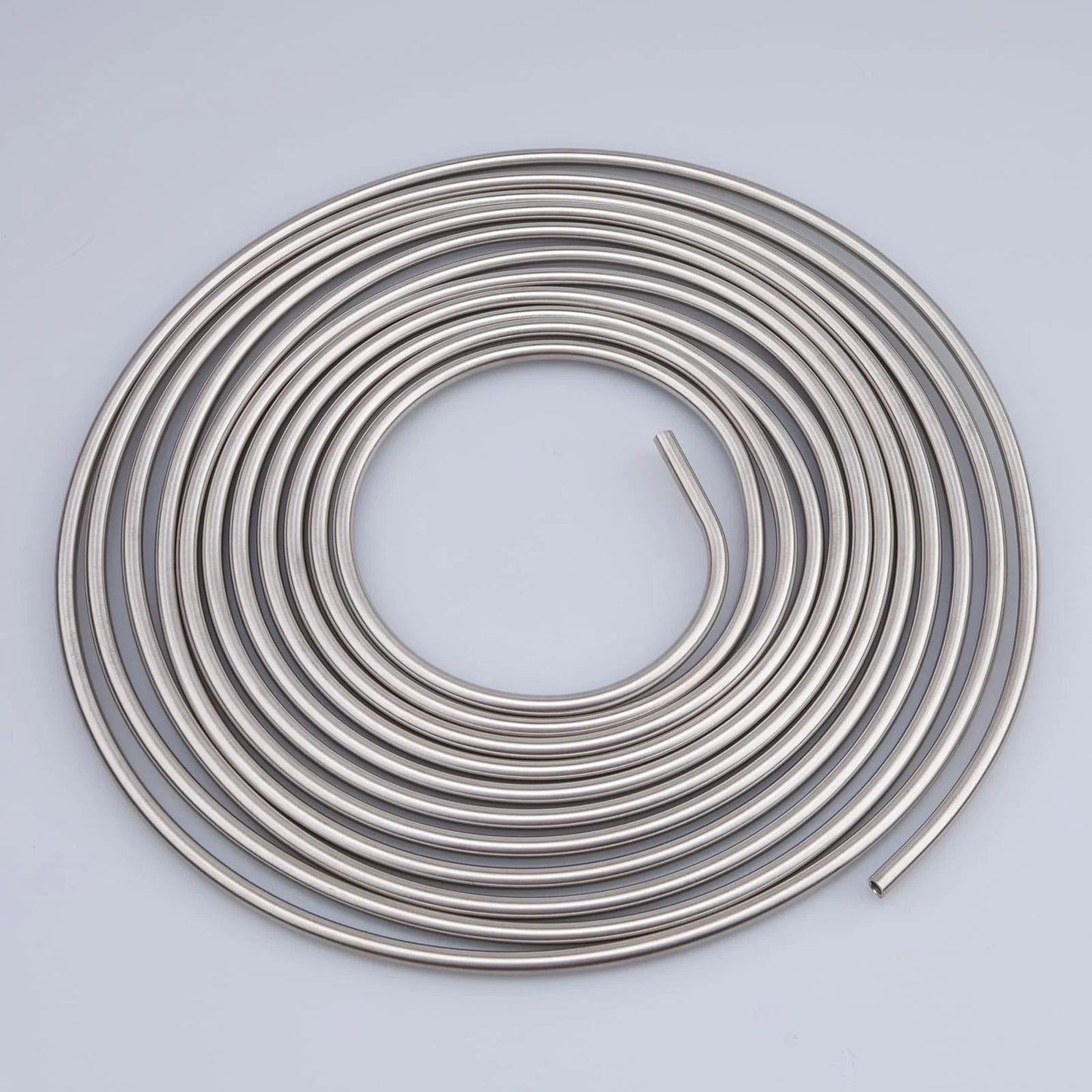 Quarter Inch Stainless Steel Brake Line Coil, 16 Feet Long Hard Tubing, 304 Stainless Steel with 0.7mm Wall coiled on a surface