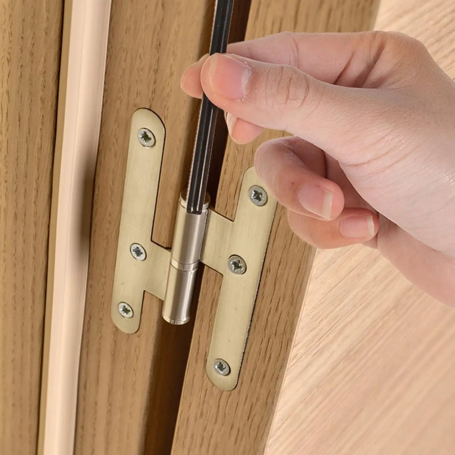 Close-up of hand installing a Black Door Hinge Pin 3.5 Inch Replacement on a wooden door, showing pin placement for smooth door operation.