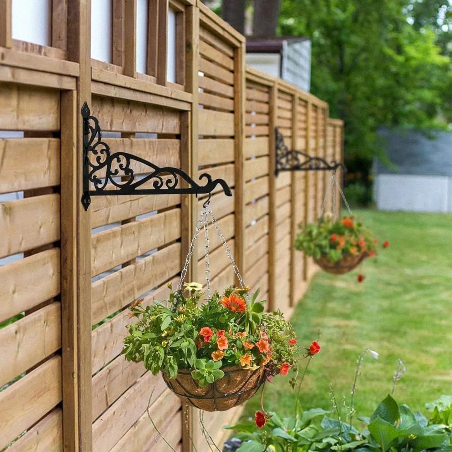 Hanging flower baskets on a wooden fence in a garden