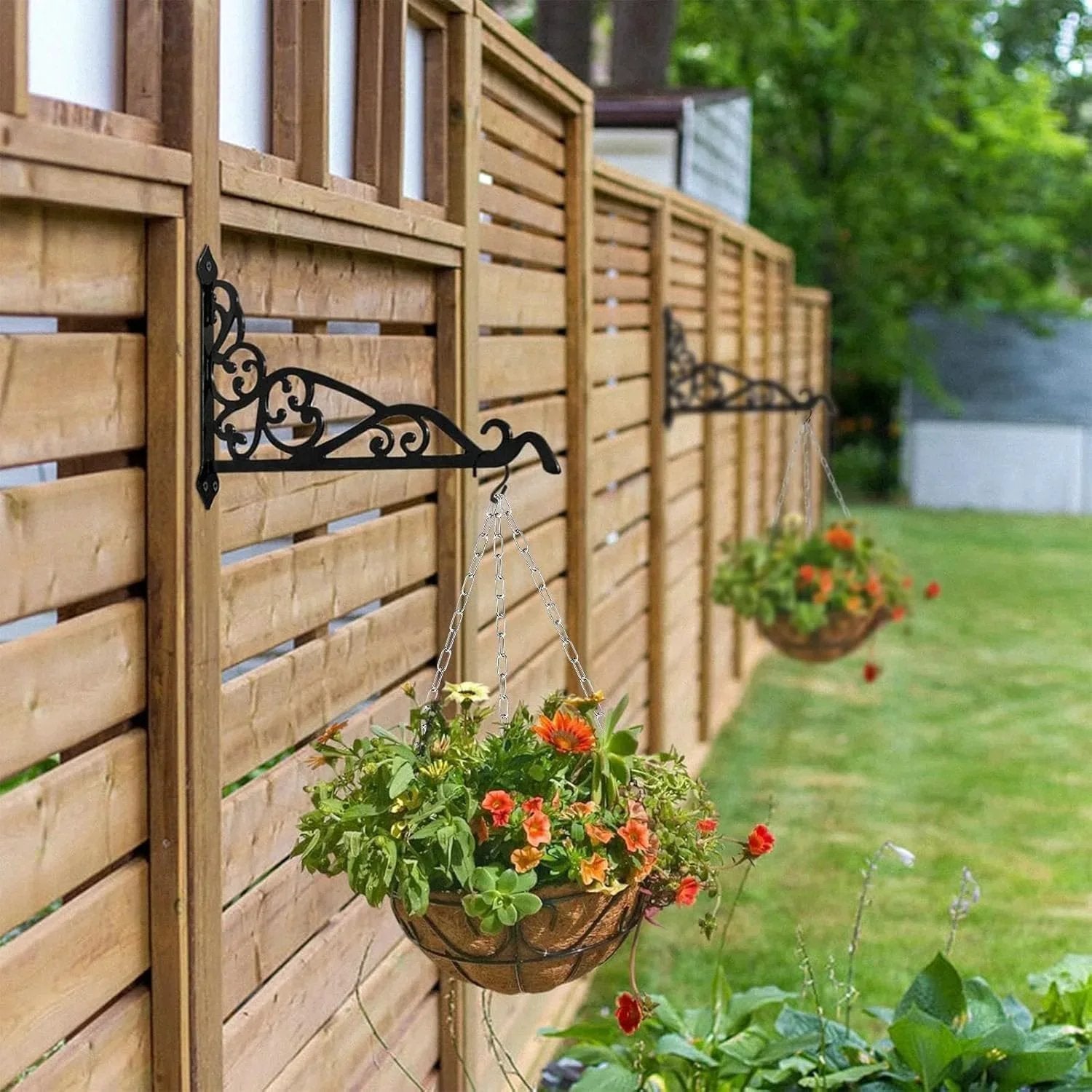 Hanging flower baskets on a wooden fence in a garden