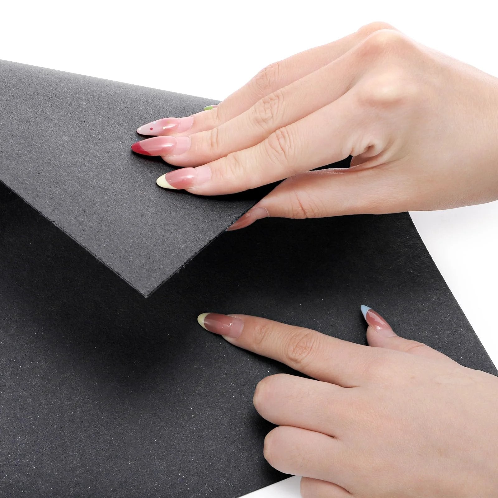 Hands holding 9-Piece Non Asbestos Gasket Paper Sheet Set Pro Grade 15 x 11.8 Inches High Temperature Gasket Material