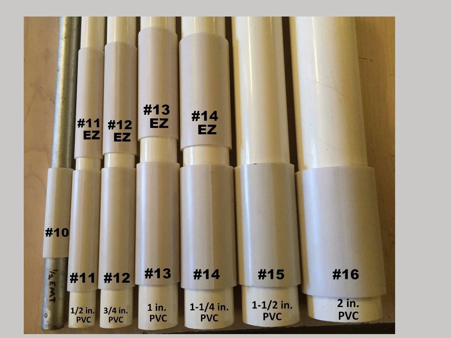 Various PVC pipe sizes from 1/2 inch to 2 inch displayed in a row with labels; suitable for DIY and construction projects.